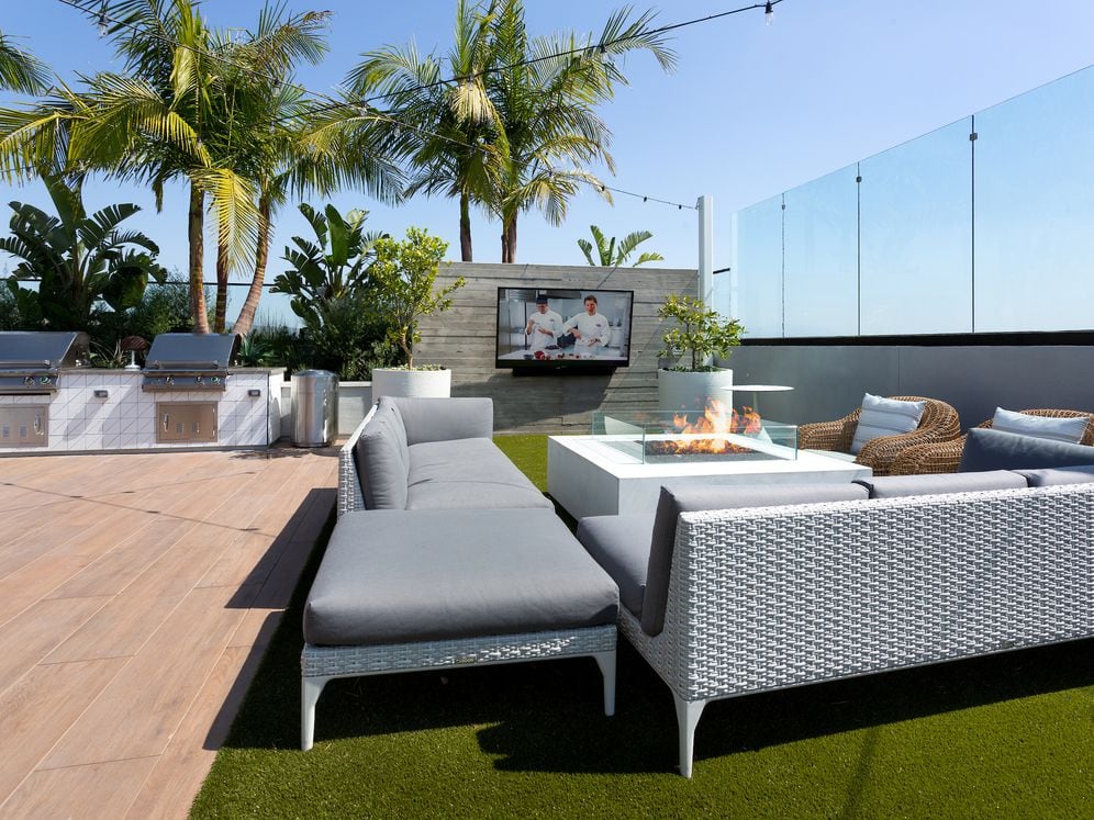 Building A rooftop lounge with grills, fireplace and seating