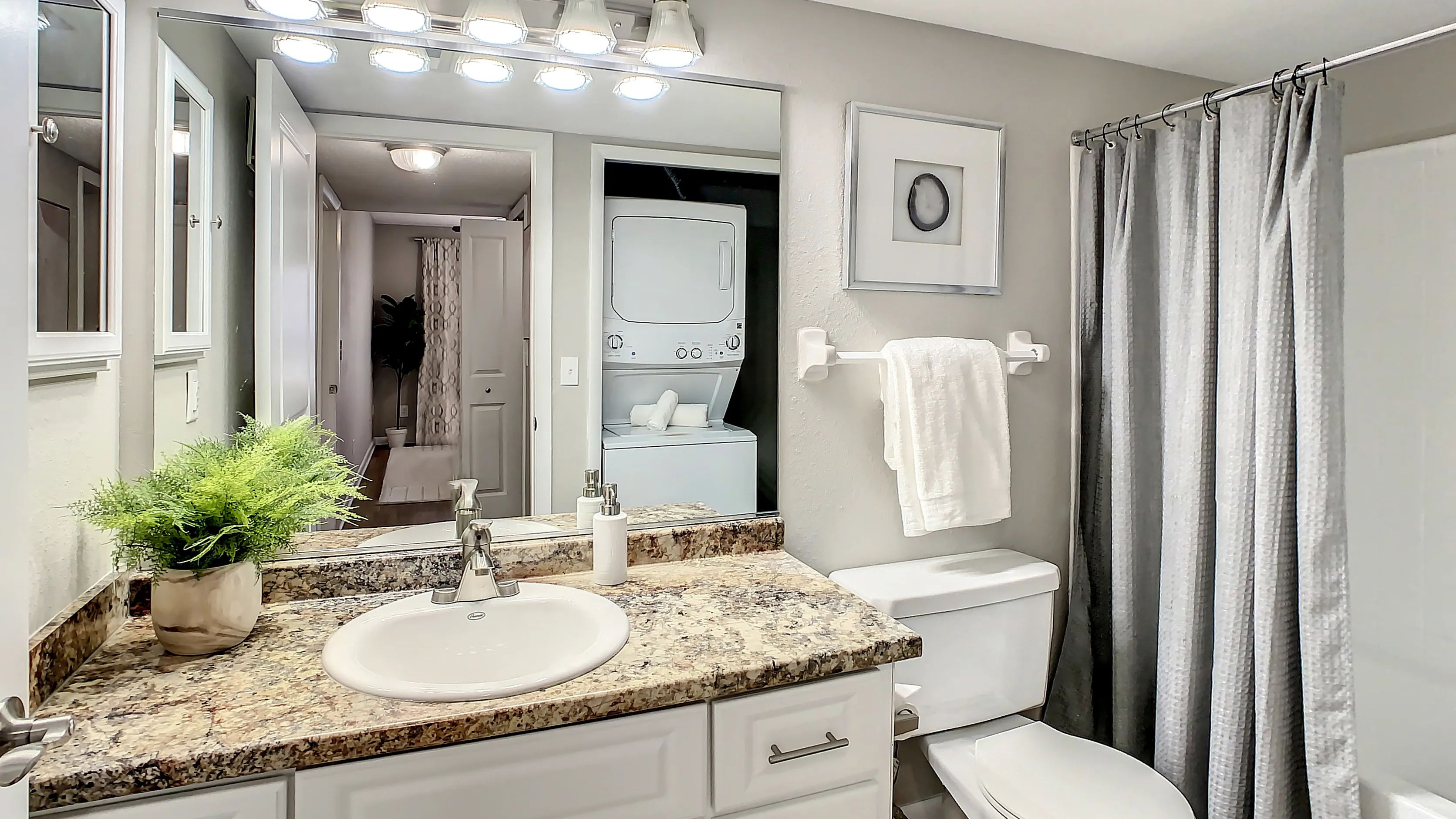 Pamper yourself in a spa-like oasis with white cabinets, granite-inspired countertops, and a relaxing garden.