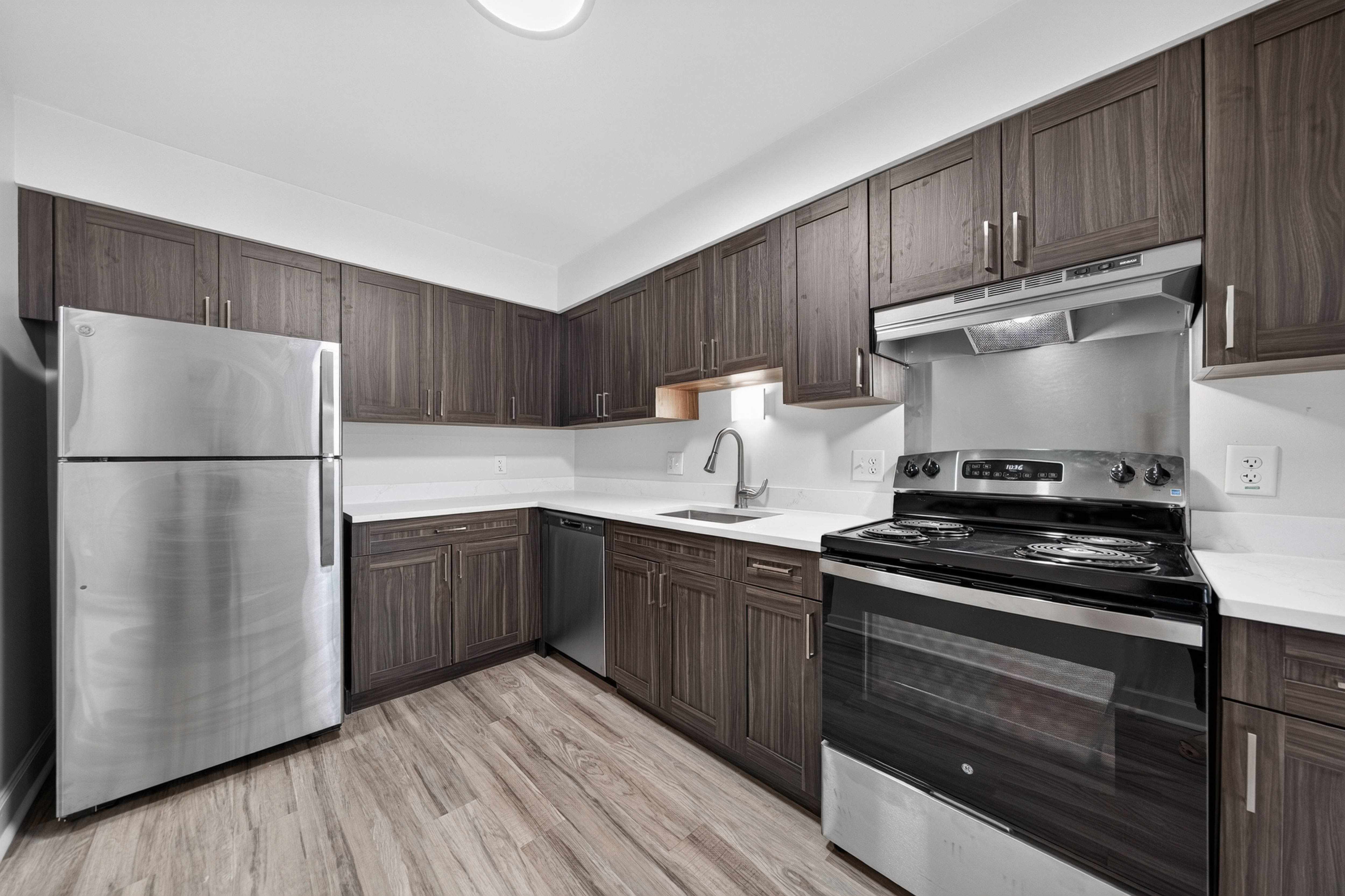 Modern kitchen with stainless steel appliances at Franklin River Apartments in Southfield, MI.