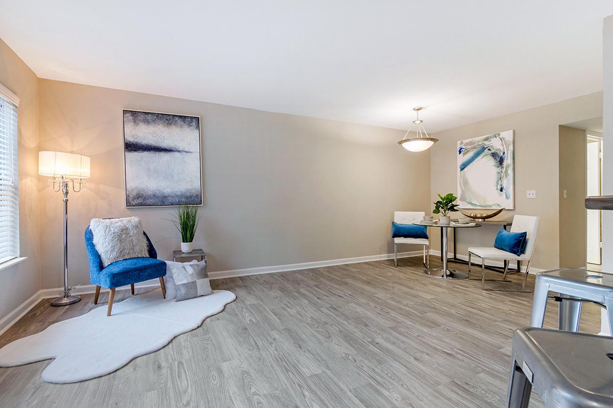 Relax in your spacious living room featuring wood-style flooring and large windows.