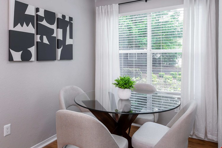 Drenched in natural light, this charming solarium creates the perfect corner for casual meals, coffee chats, or a quiet morning read.