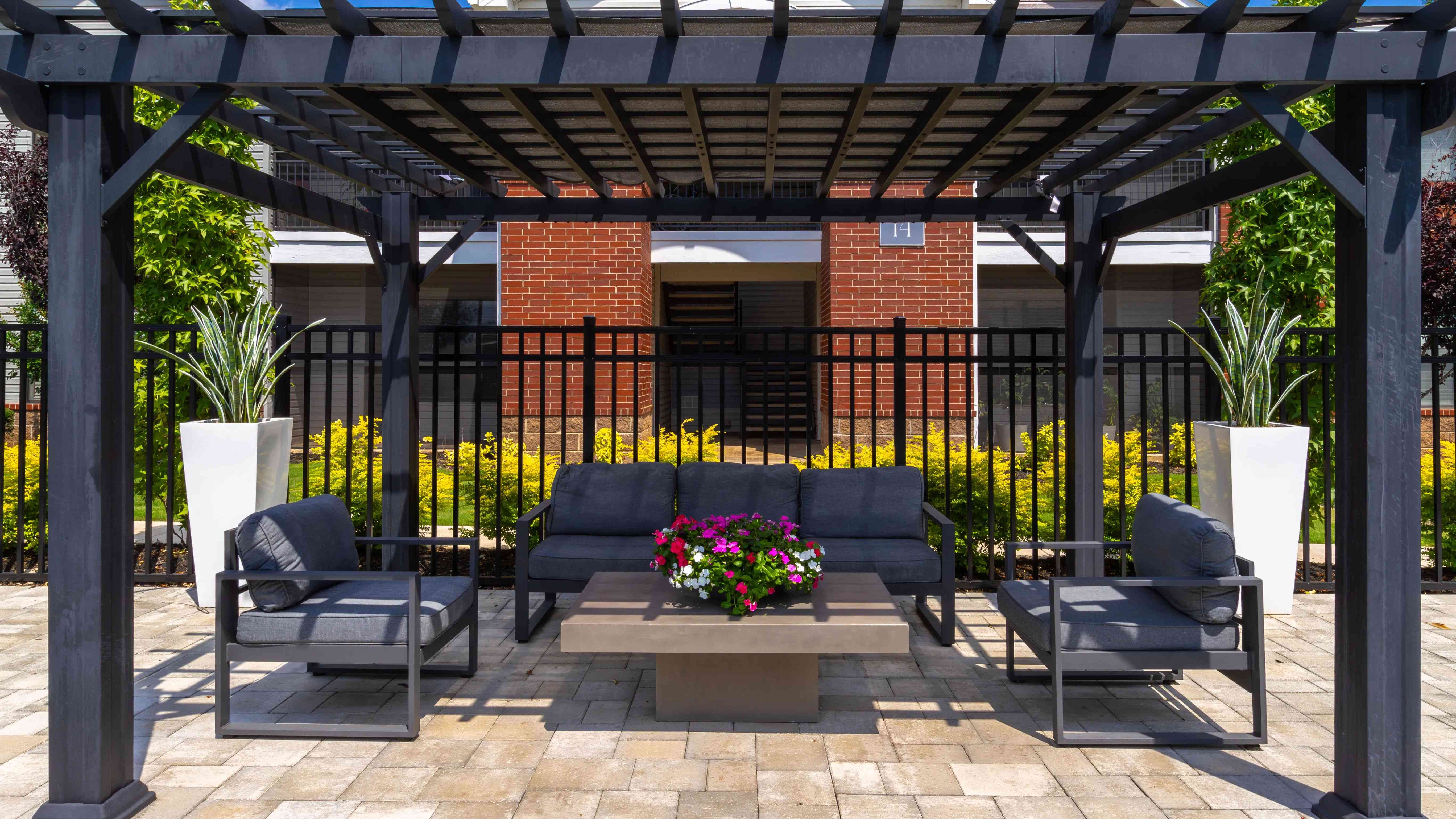 Unwind in style at our poolside lounge, featuring comfortable seating under a stylish pergola, perfect for relaxing and socializing.