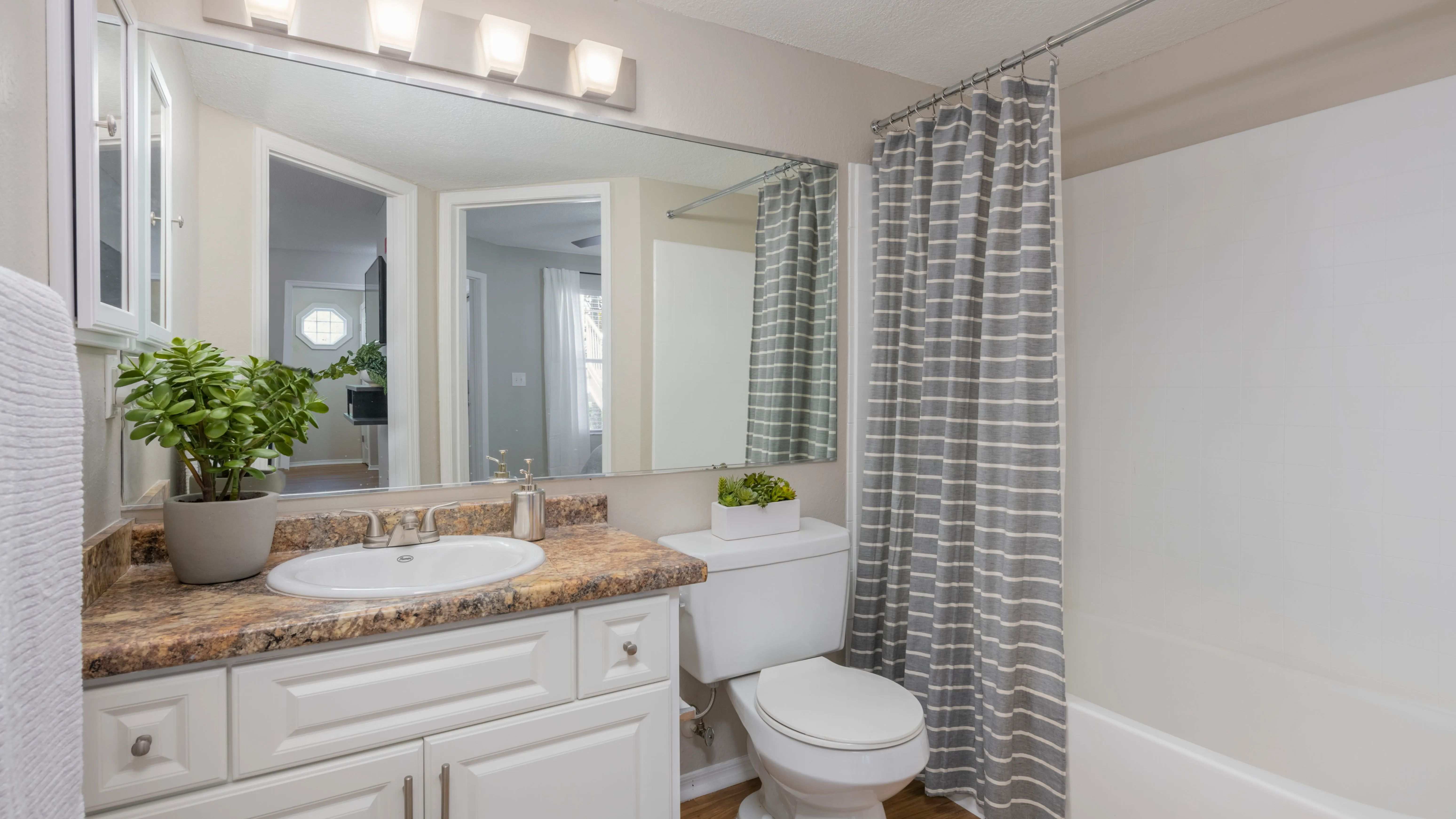 Partake in a realm of luxury with sleek, updated bathrooms offering ample counters and spacious mirrors. 