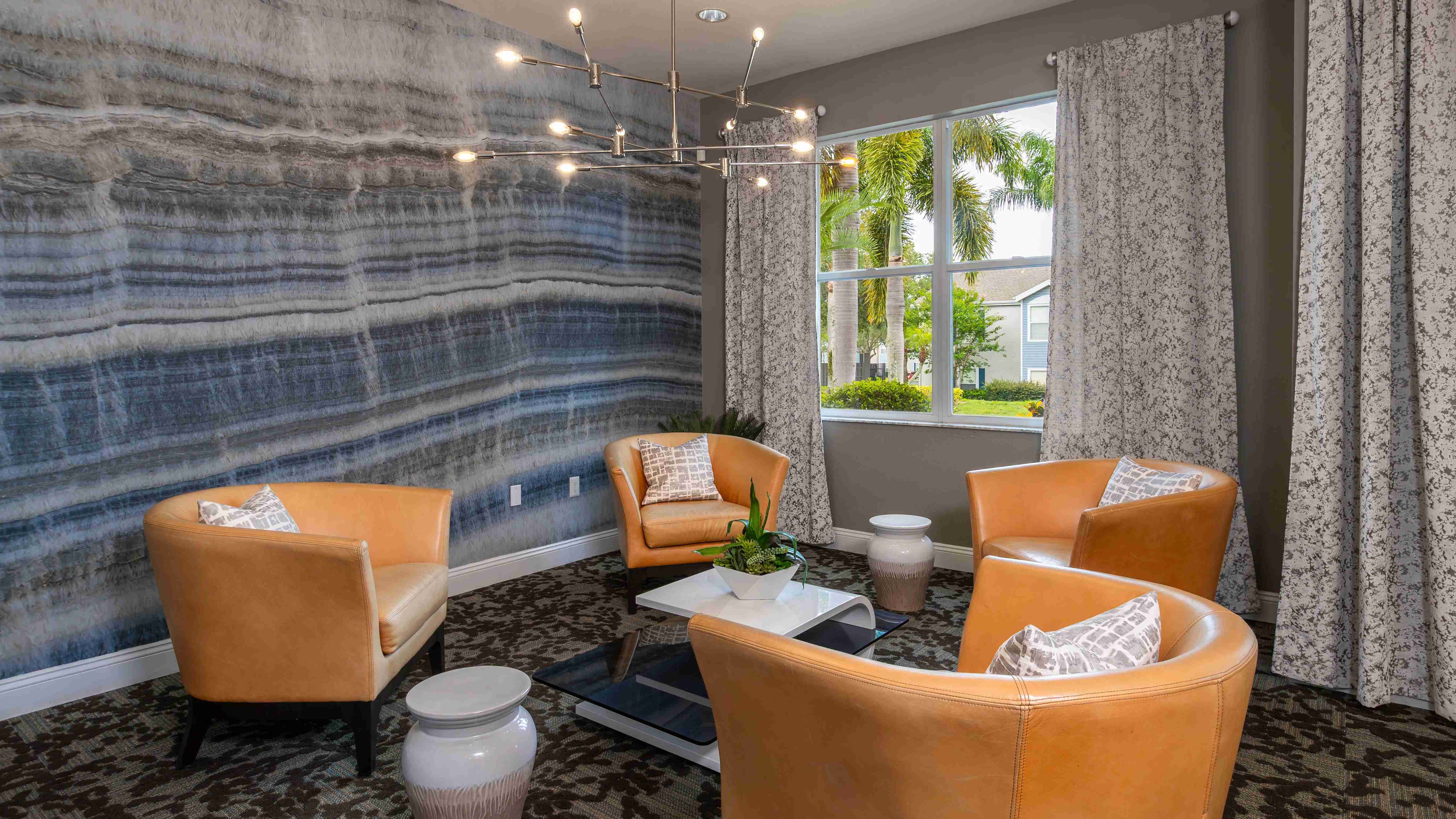 Our clubhouse lounge combines elegant textures, natural lighting, and designer furnishings to create a warm and welcoming space.