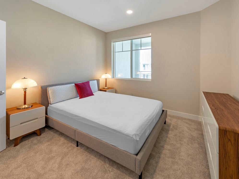 Furnished+ apartment homes feature queen bed with mattress, two pillows, dresser, nightstands, lamp, and mirror. (Representative Image – exact items and style of furnishings may vary)