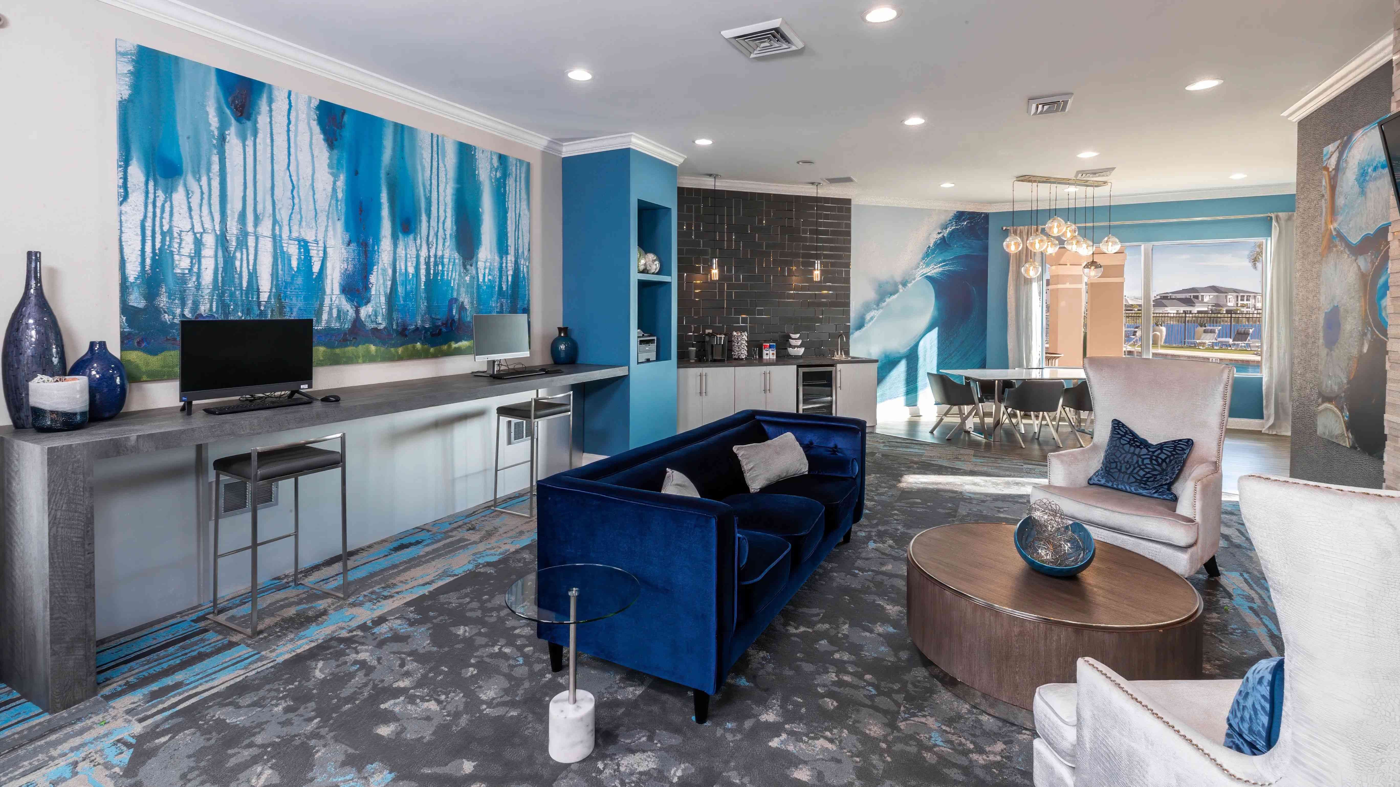 
Resident clubhouse featuring a modern lounge, workstations, and stylish seating, a perfect place to catch up on some work.