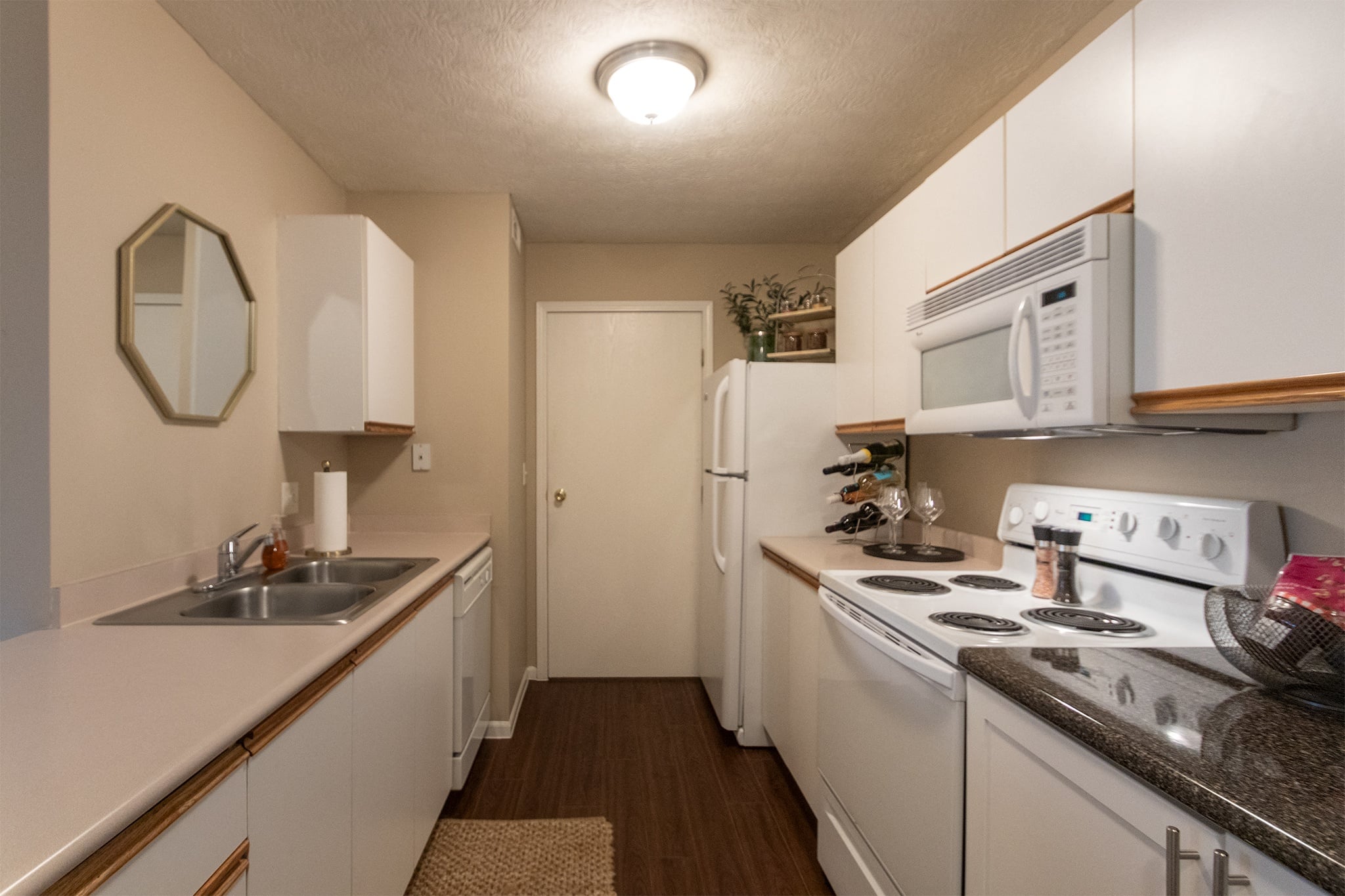 Our model Liberty kitchen features both upgraded cabinetry with dark countertops and classic cabinetry with light countertops.