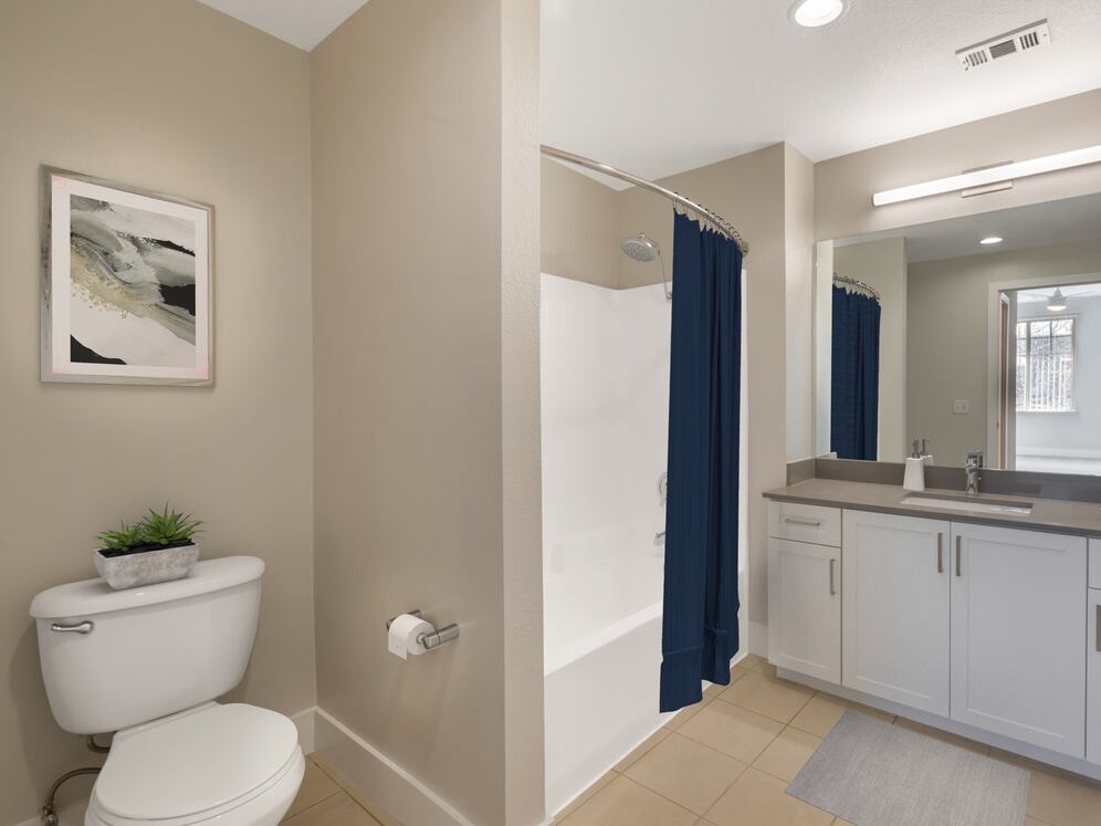 Renovated Package I bath with white cabinetry, grey quartz countertops, and hard surface flooring
