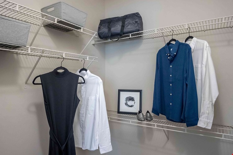 Experience unmatched organization and style in the master bedroom's walk-in closet with staggered shelving.