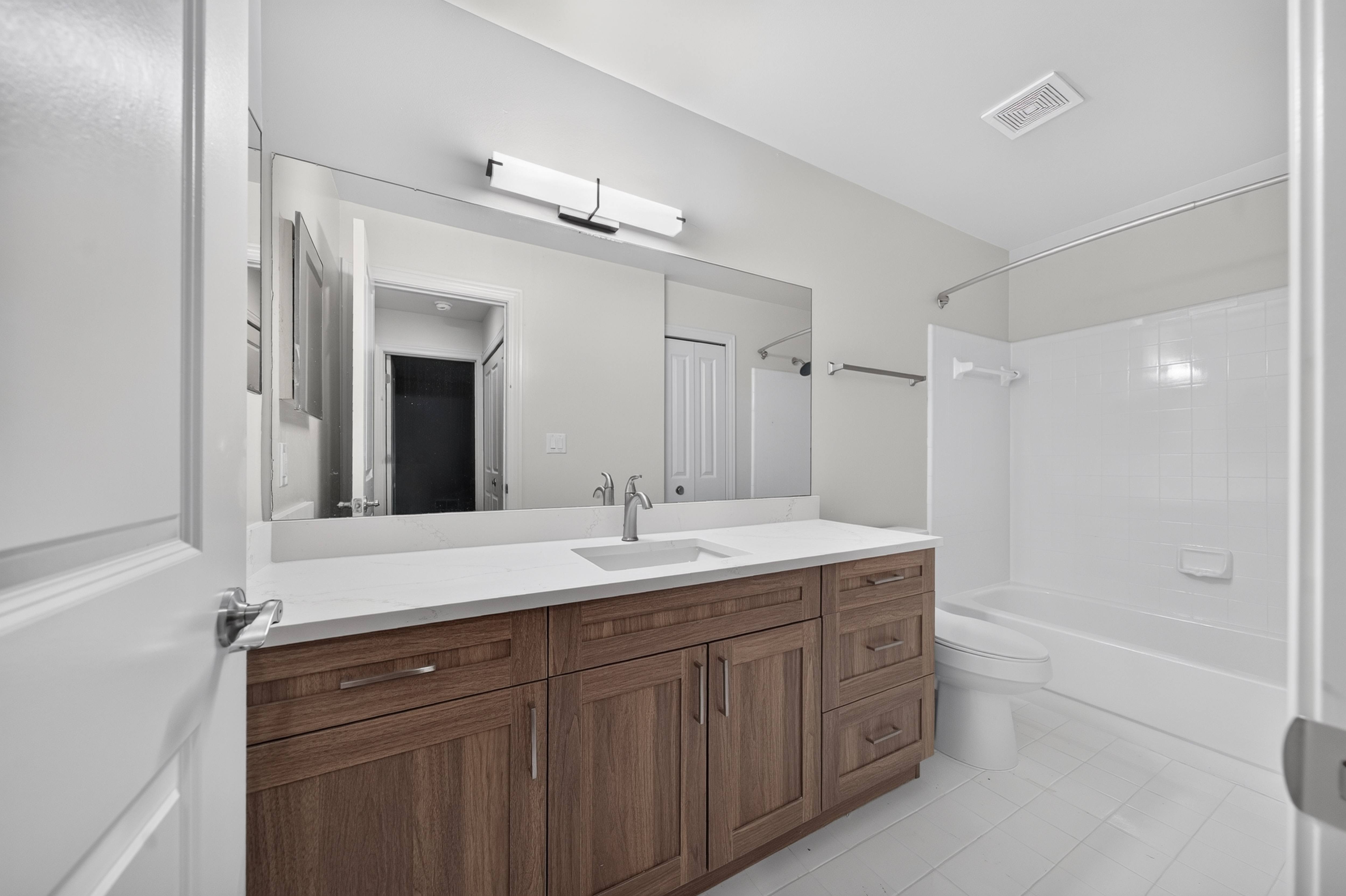 Modern bathroom with tub at Park Lane Apartments in Southfield, MI.