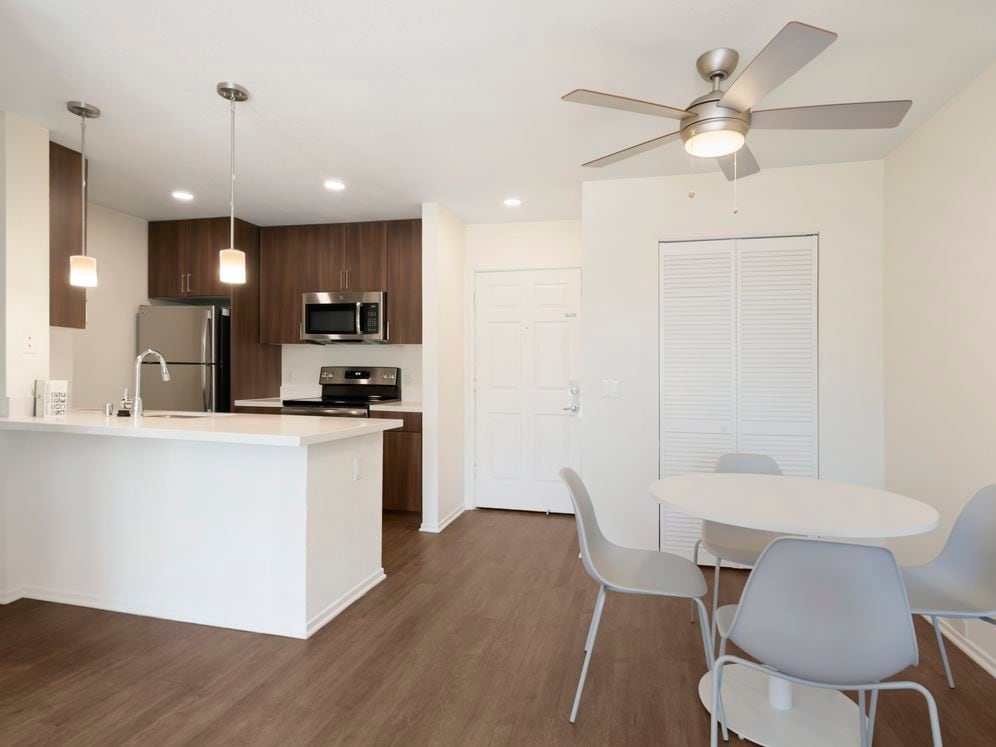 Furnished+ apartment homes include a dining set (Representative Image – exact items and style of furnishings may vary)