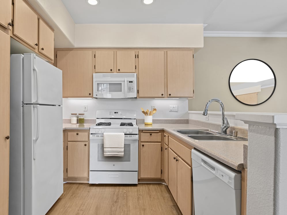 Classic Package I kitchen with white appliances, laminate countertops, oak cabinetry, and hard surface flooring
