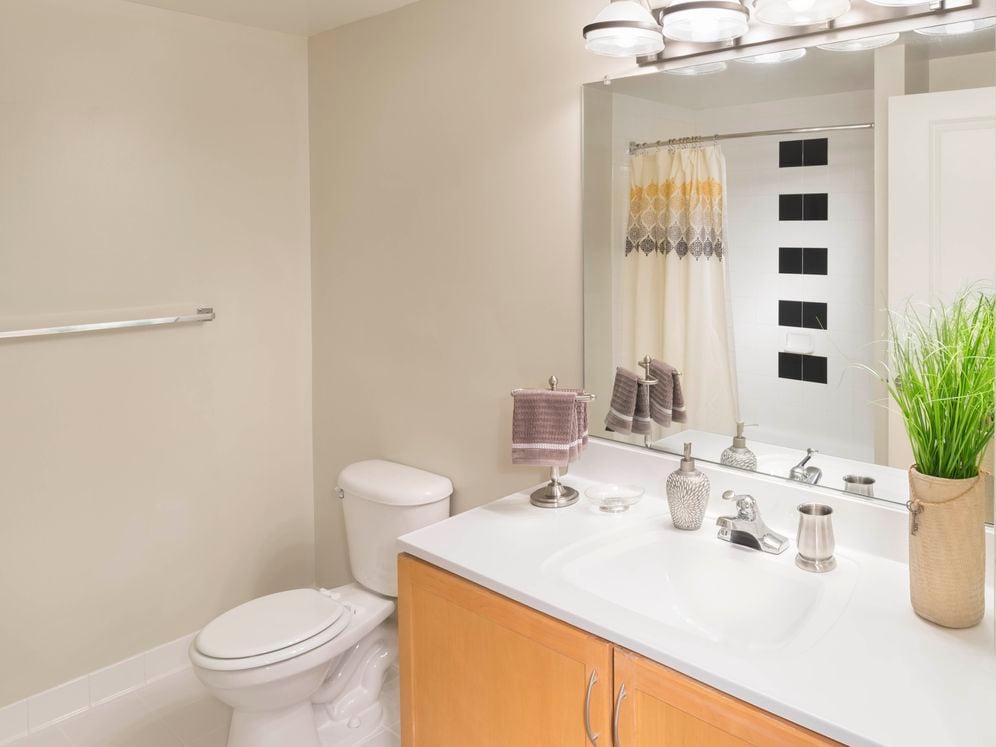 Bath with white countertop and tiled tub