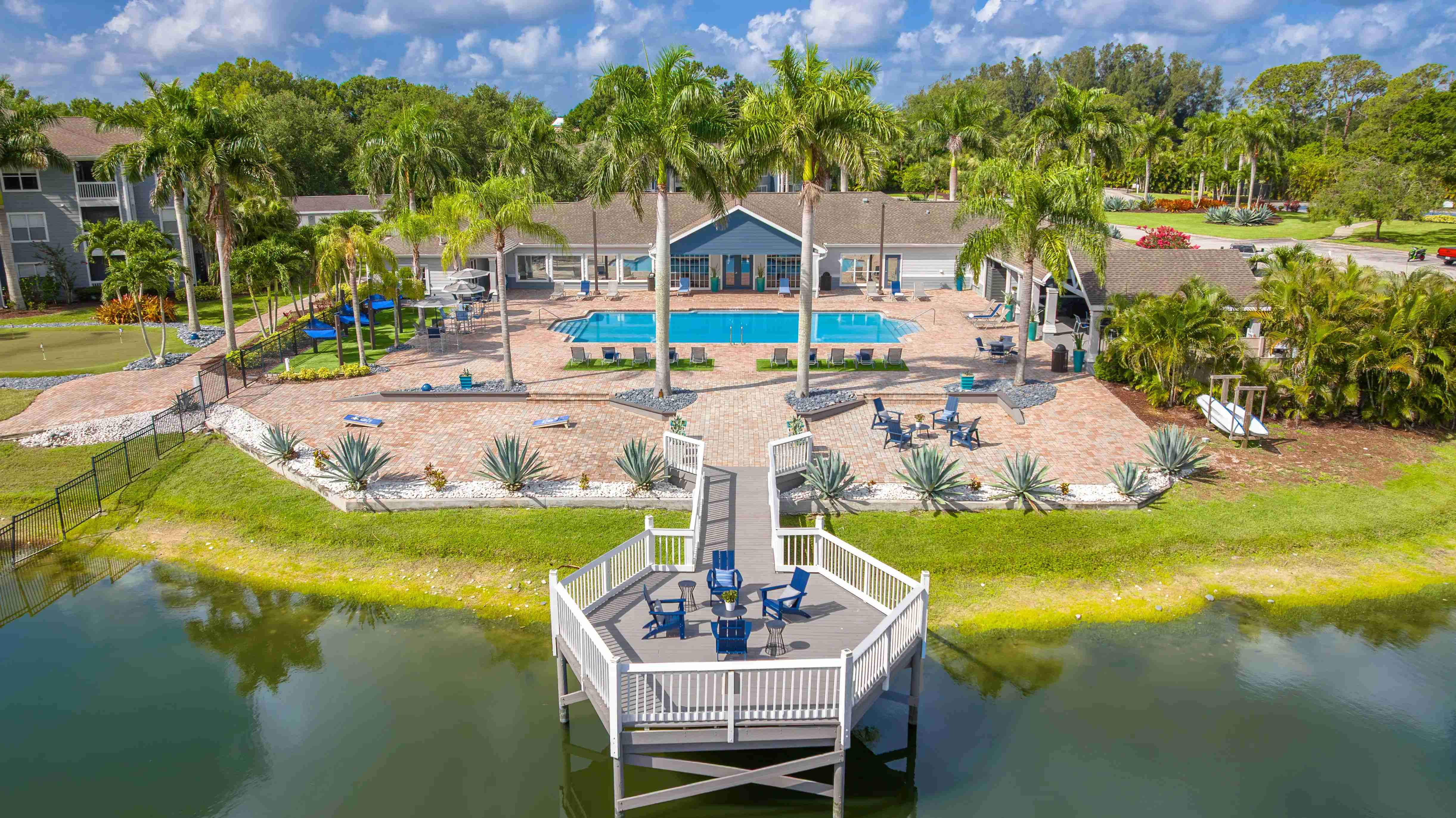 Relax in style at Grand Oaks with a sparkling pool, palm-lined sun deck, and a peaceful lakeside gathering space—perfect for unwinding or socializing.