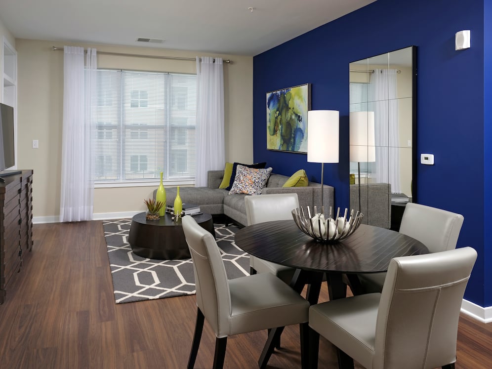 Hunt Valley - Living and dining area with accent wall and hard surface flooring