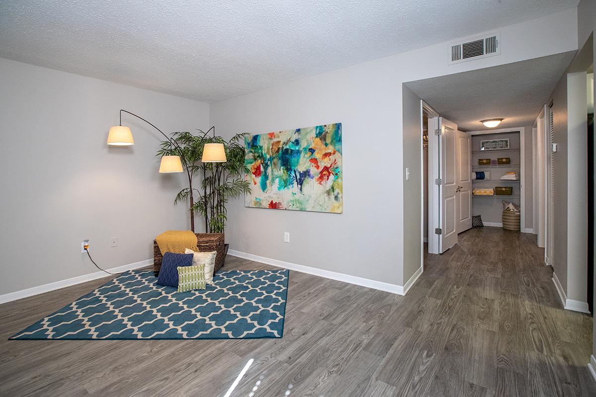 Living rooms feature wood-style flooring.