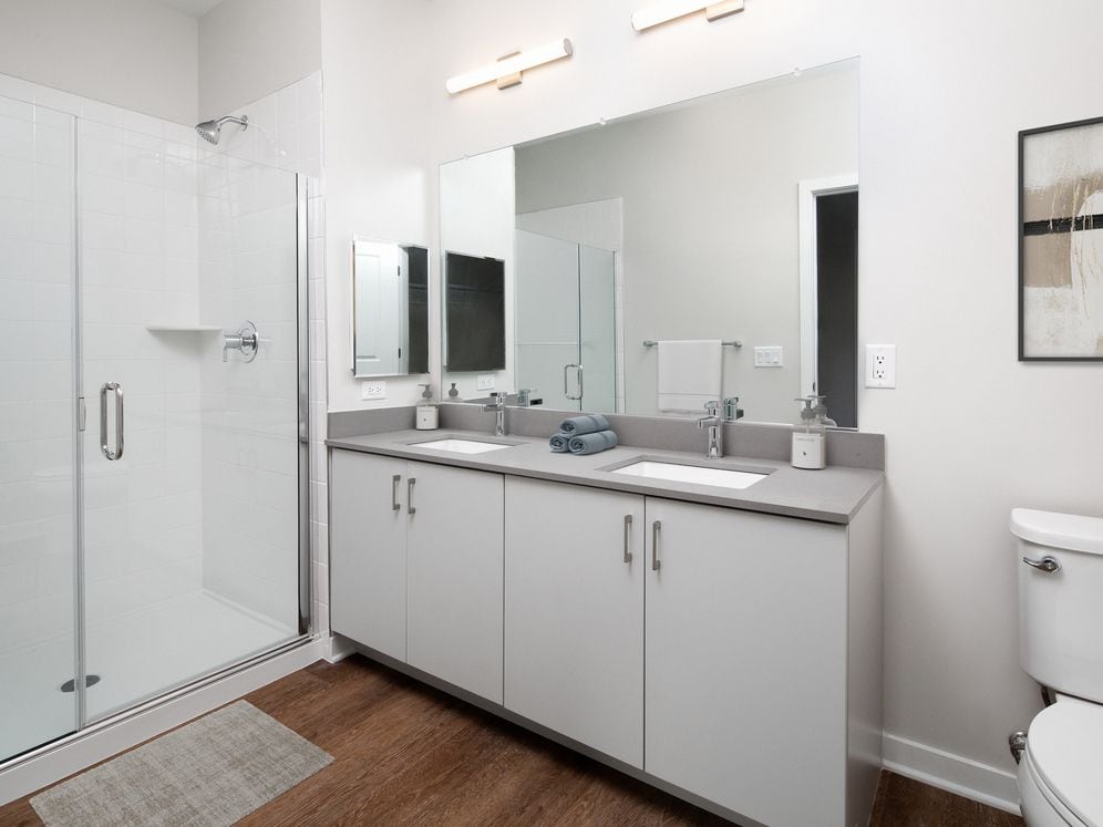 Design Collection I (North Building) Bath with white cabinetry, grey quartz countertop, and hard surface flooring