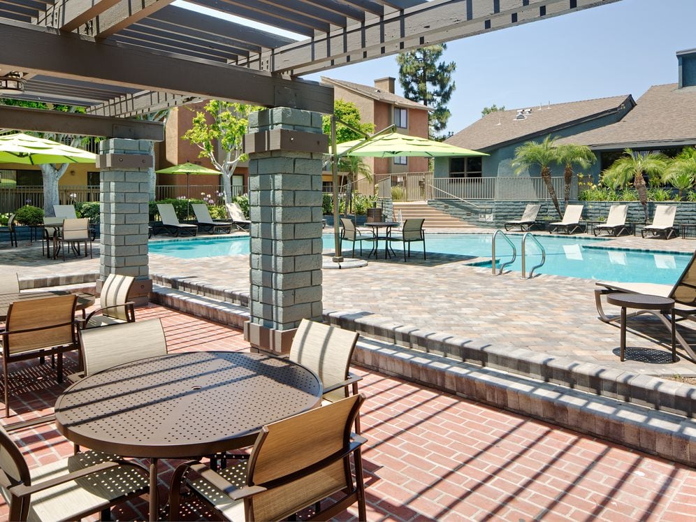 Swimming pool and sundeck with picnic tables