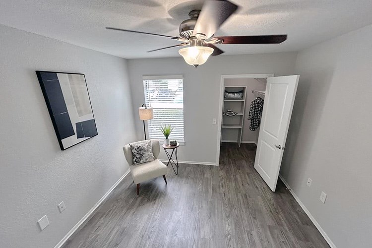 Spacious bedrooms featuring a multi-speed ceiling fan and a spacious walk-in closet.