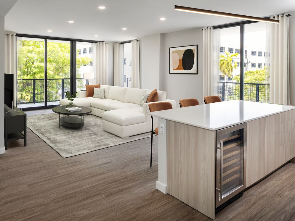 Upgrade Collection I kitchen with light wood cabinetry, grey tile backsplash, white quartz countertops, stainless steel appliances, and wine fridge