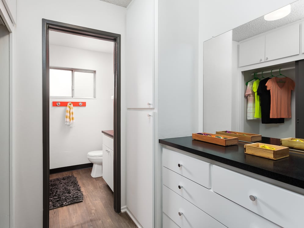 Classic Package II bath with black laminate countertops, white cabinetry, and hard surface flooring