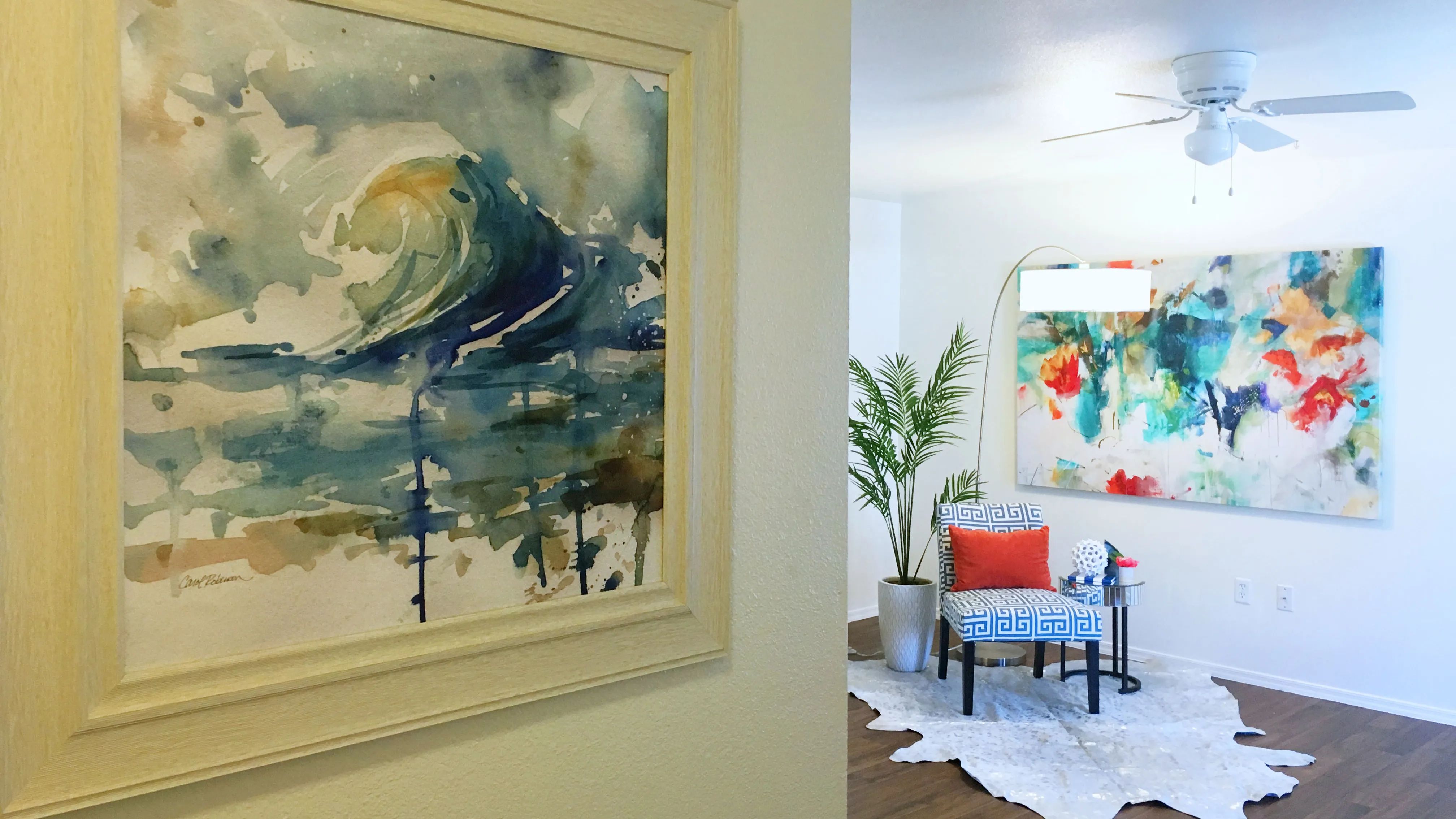 Enjoy the warmth of wood-style flooring in our inviting, open living rooms featuring a ceiling fan.