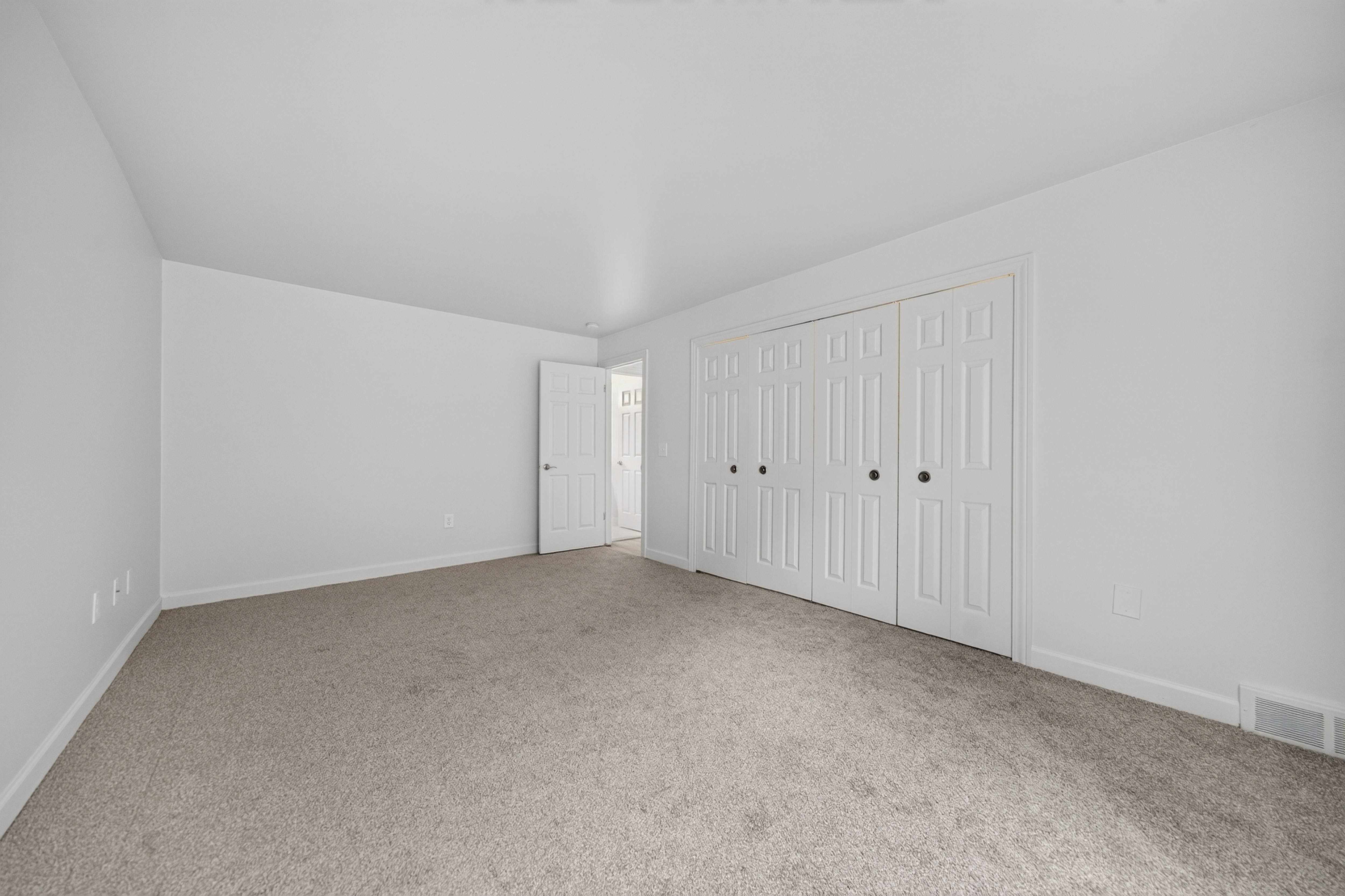 Cozy bedroom with ample storage space at Franklin River Apartments in Southfield, MI.