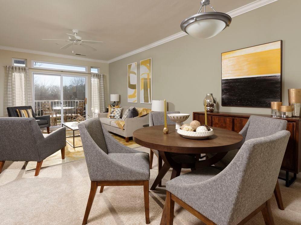 Classic Package I living and dining areas with ceiling fan and carpeted flooring