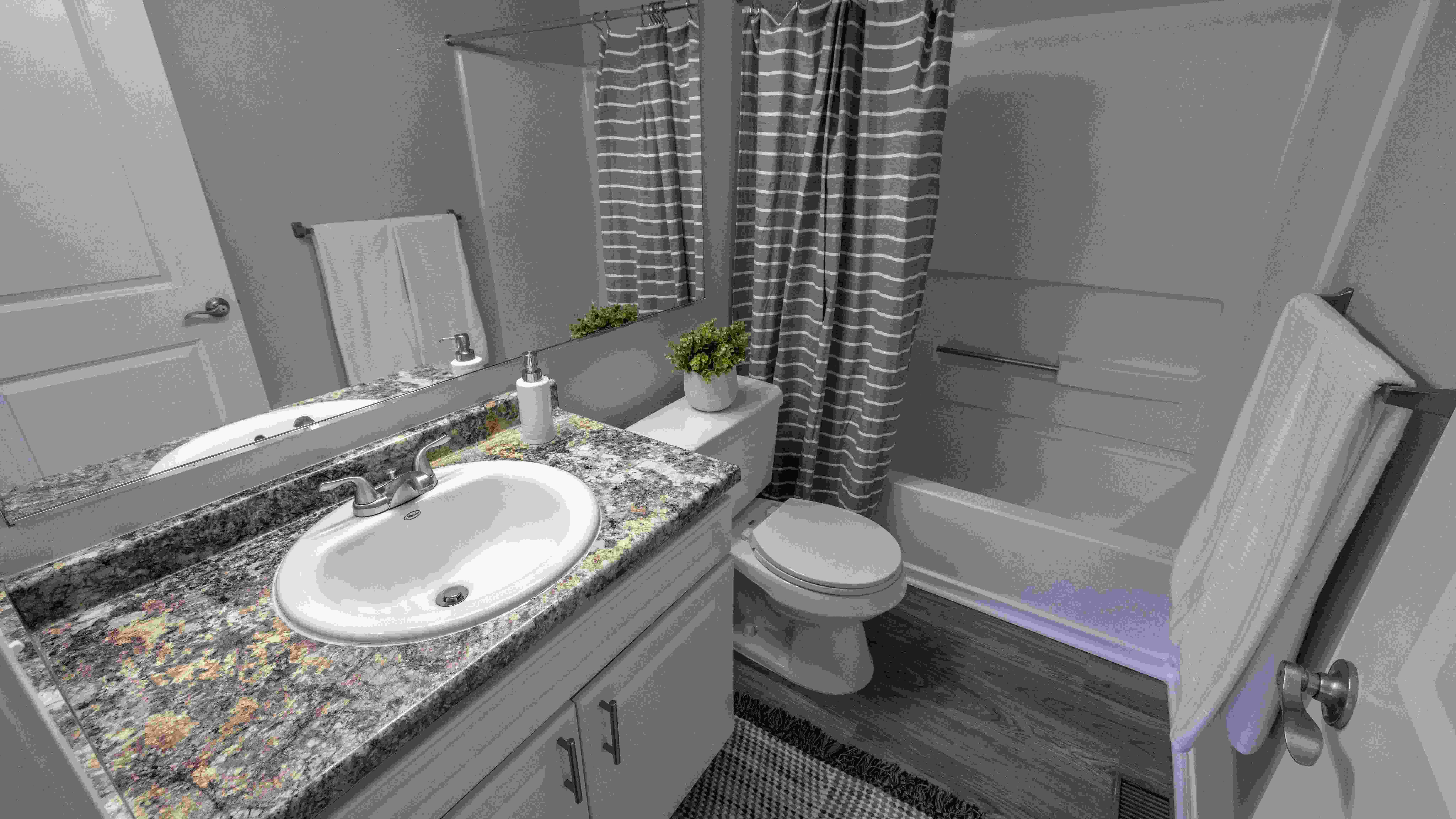 Indulge in bathrooms that radiate style. Savor the roomy vanity and contemporary aesthetics.