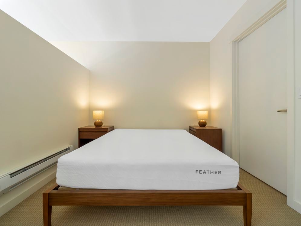 Furnished+ apartment homes feature queen bed with mattress, dresser, nightstands, and lamps (Representative Image – exact items and style of furnishings may vary)