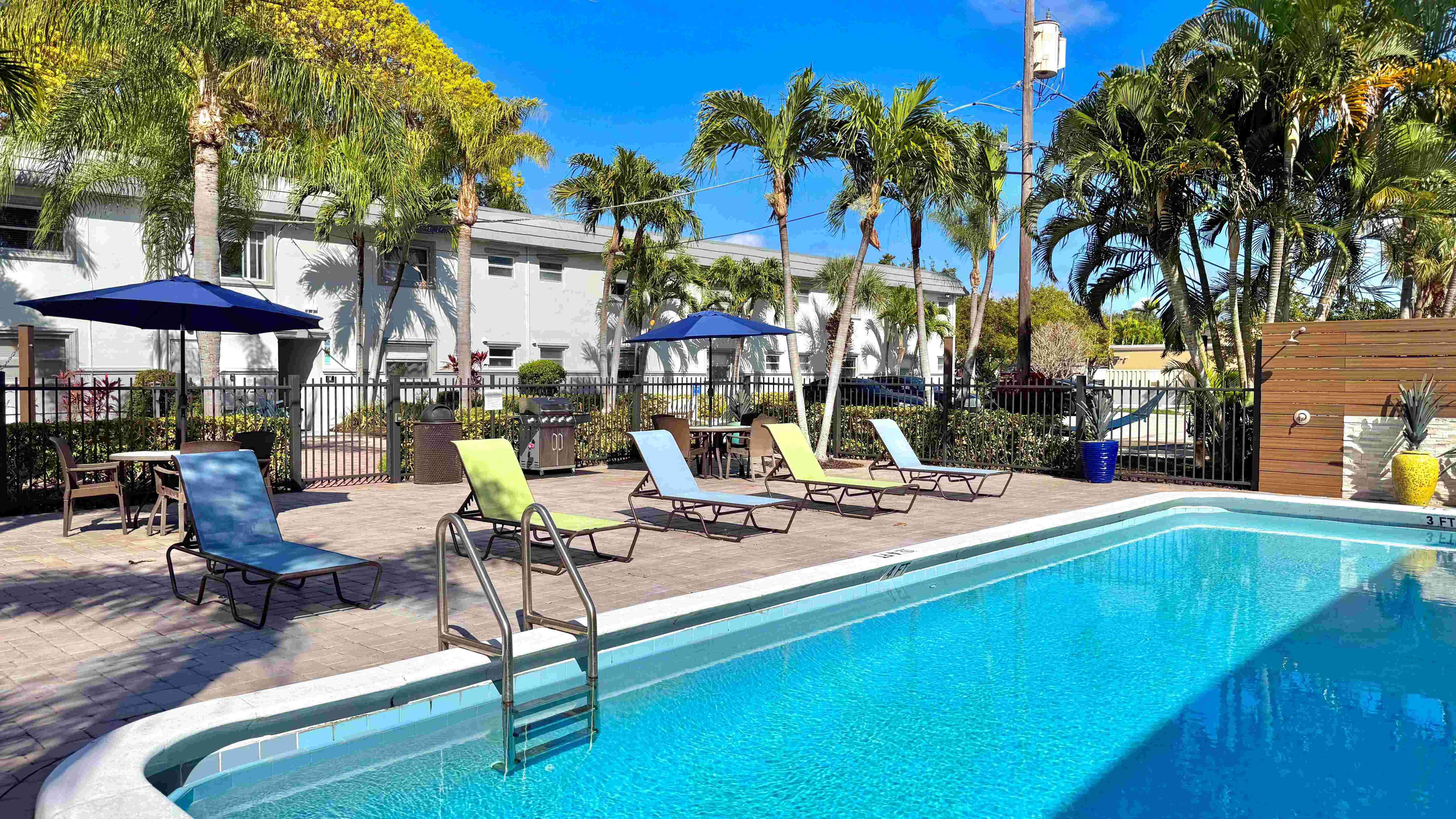 Enjoy a tranquil poolside escape with comfortable loungers and lush surroundings.