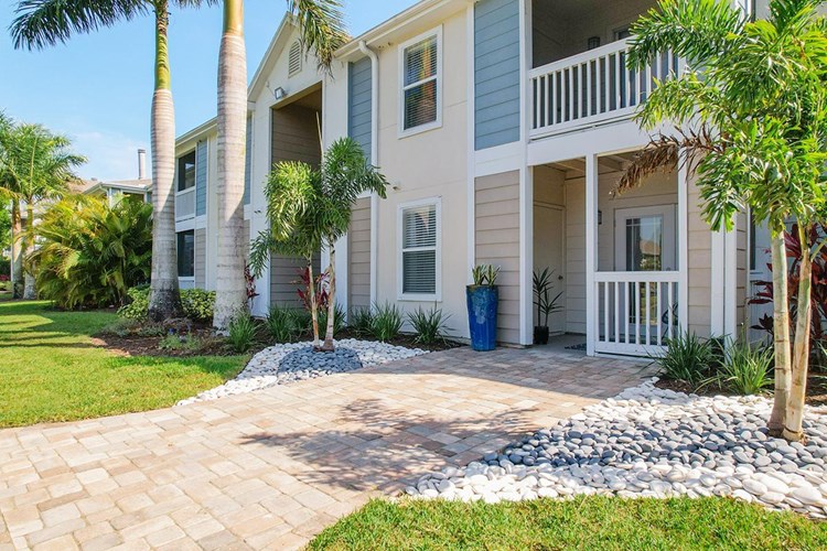 Enjoy the lush landscaping and palm trees surrounding the gated community.
