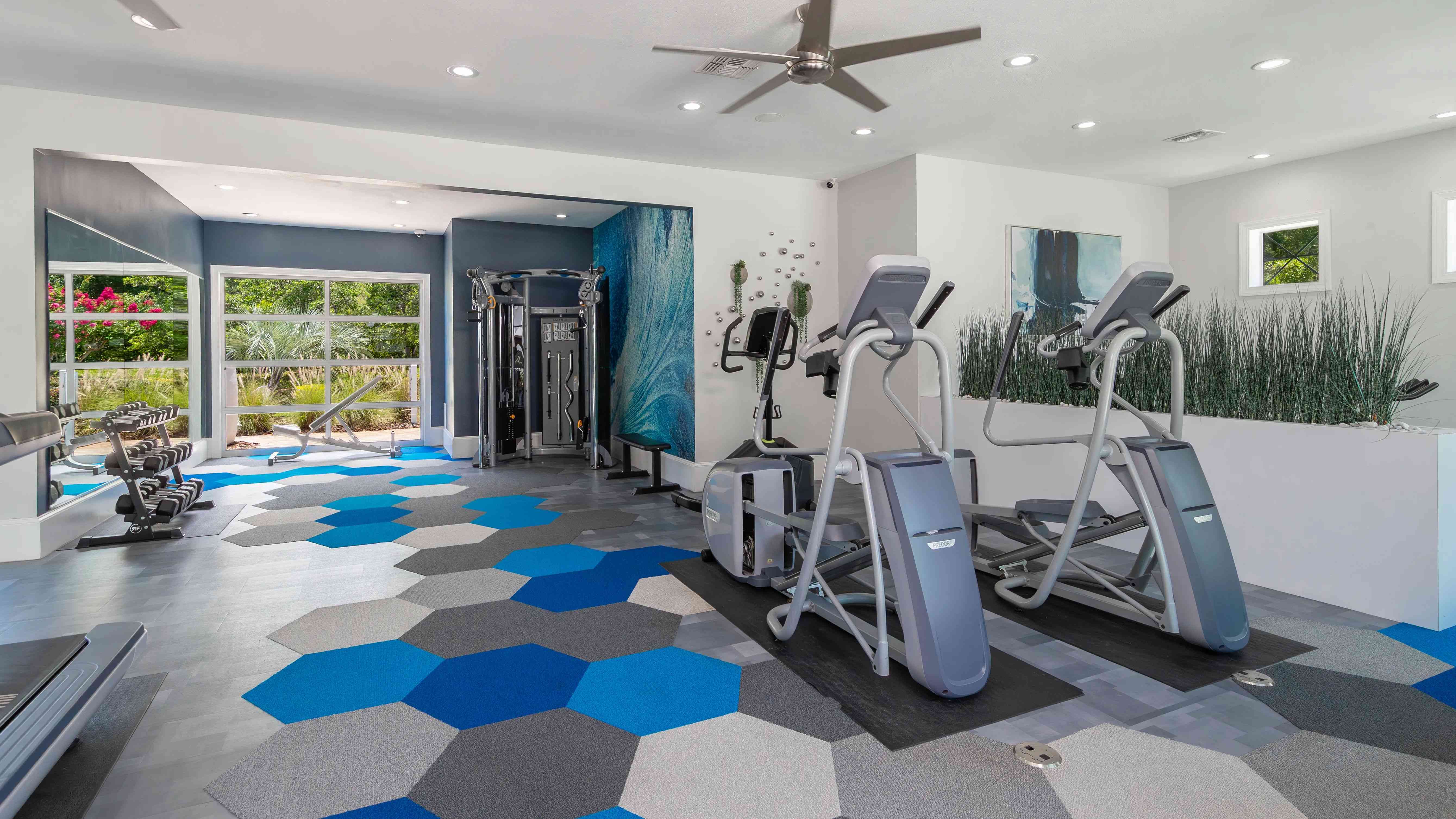 Whether you're hitting the elliptical or strength training, our modern gym space offers a colorful, motivating setting to crush your goals.