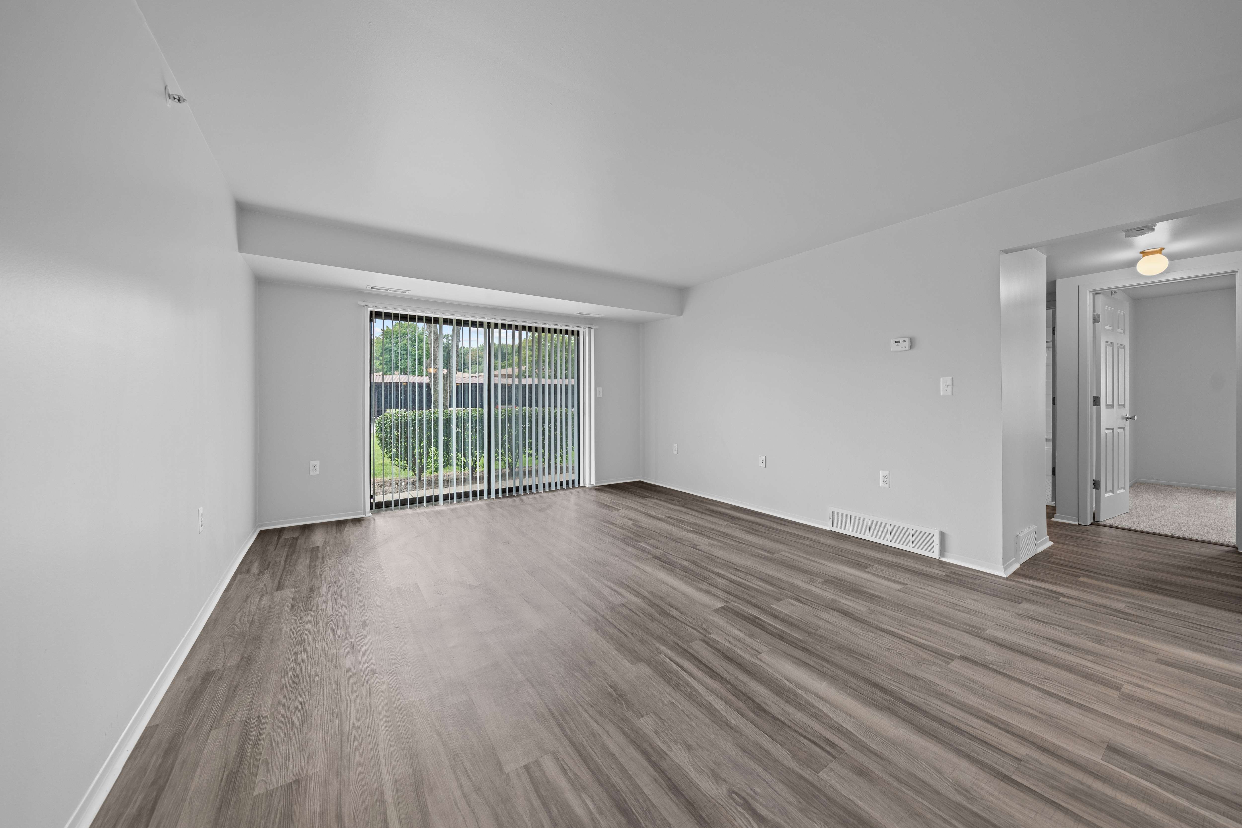 Spacious living room with natural light at Westwood Village Apartments in Westland, MI
