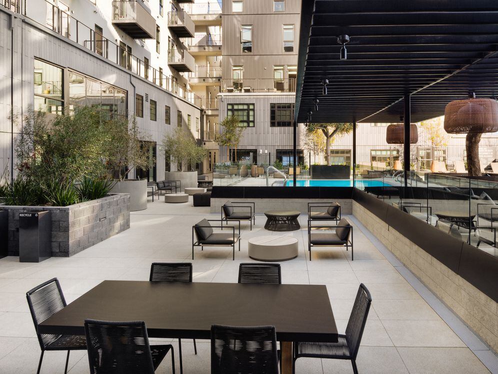 Poolside courtyard with grills and seating