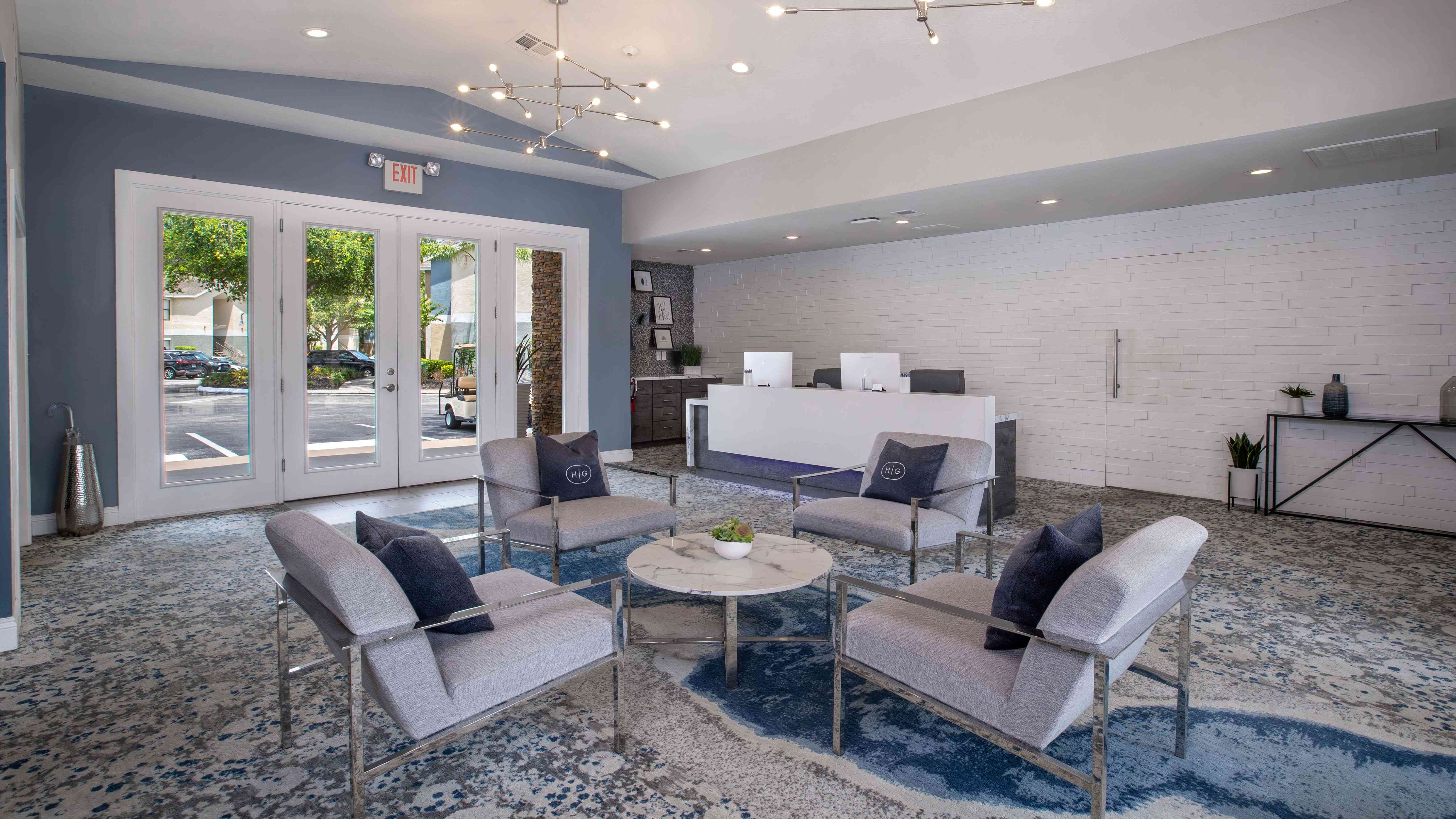 Step into comfort at the Harper Grand clubhouse—featuring modern seating, a welcoming atmosphere, and a sleek leasing center designed for your convenience.