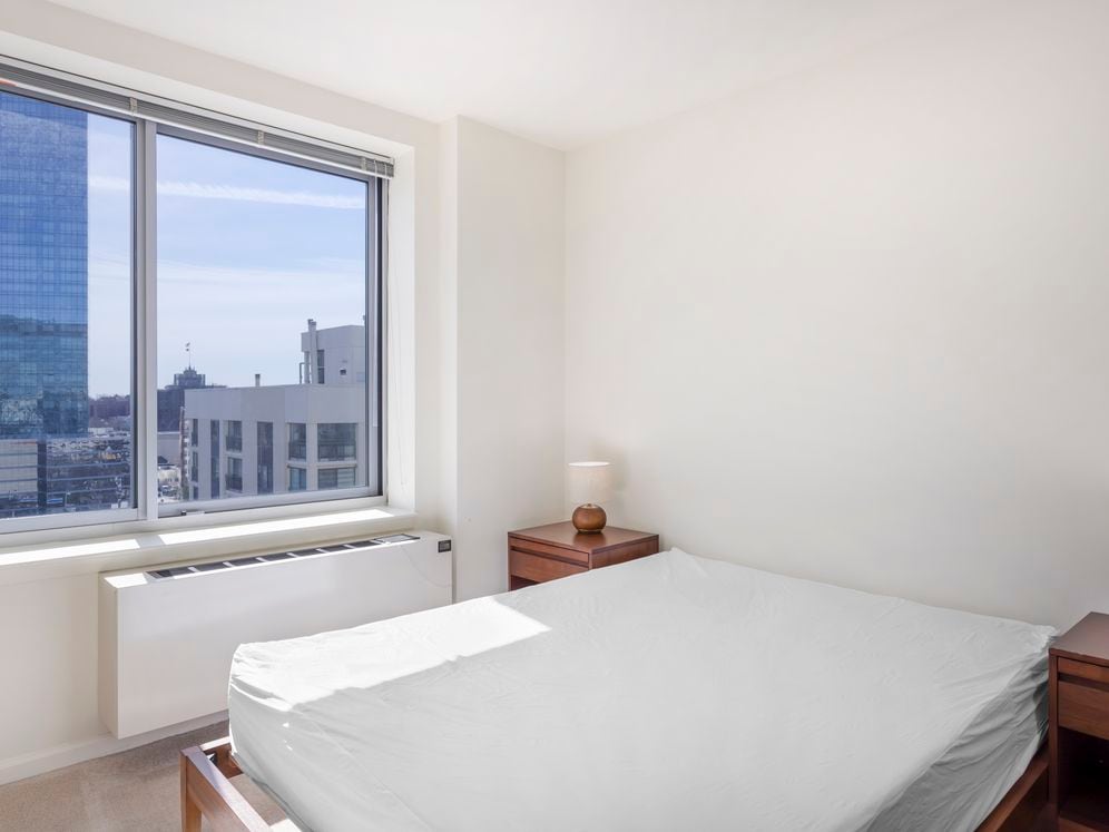 Furnished+ apartment homes feature queen bed with mattress, dresser, nightstands, and lamps (Representative Image – exact items and style of furnishings may vary)