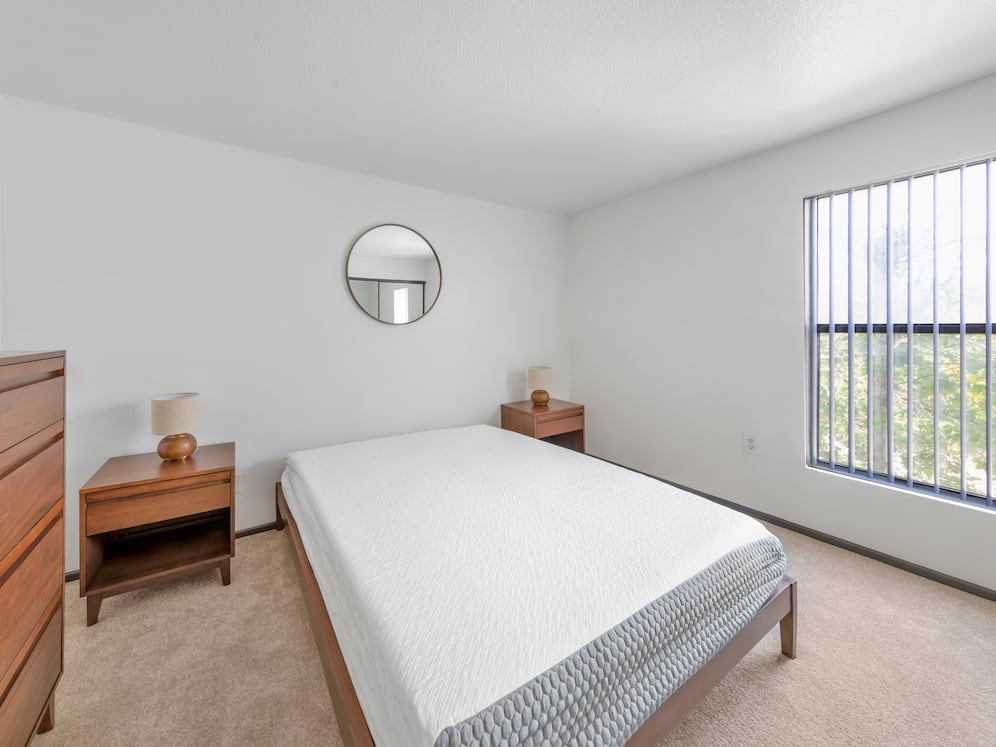 Furnished+ apartment homes feature queen bed with mattress, dresser, nightstands, and lamps (Representative Image – exact items and style of furnishings may vary)