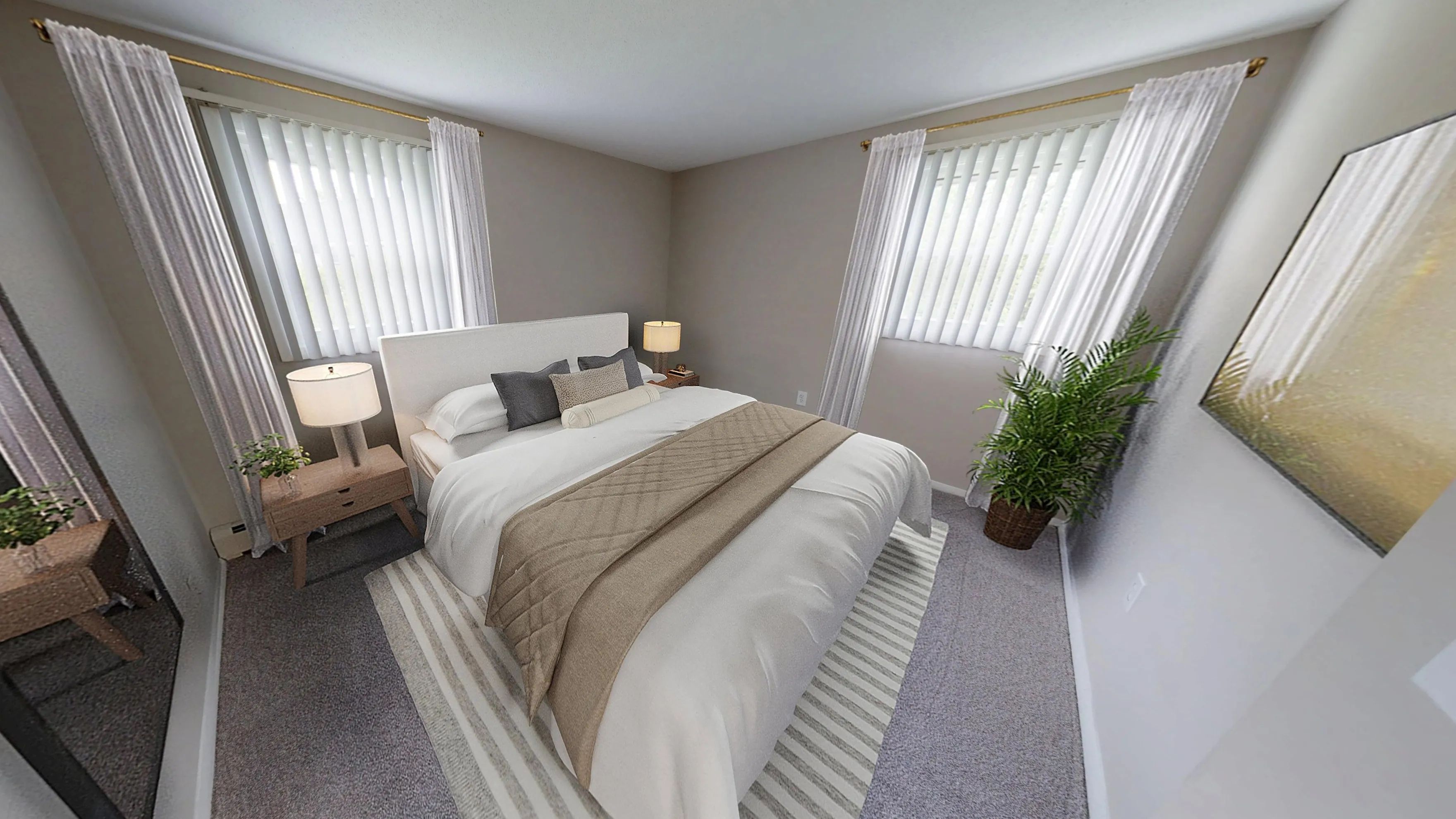 The Dickenson's bedroom showcases soft carpeting, neutral tones, and double windows that fill the space with natural light.