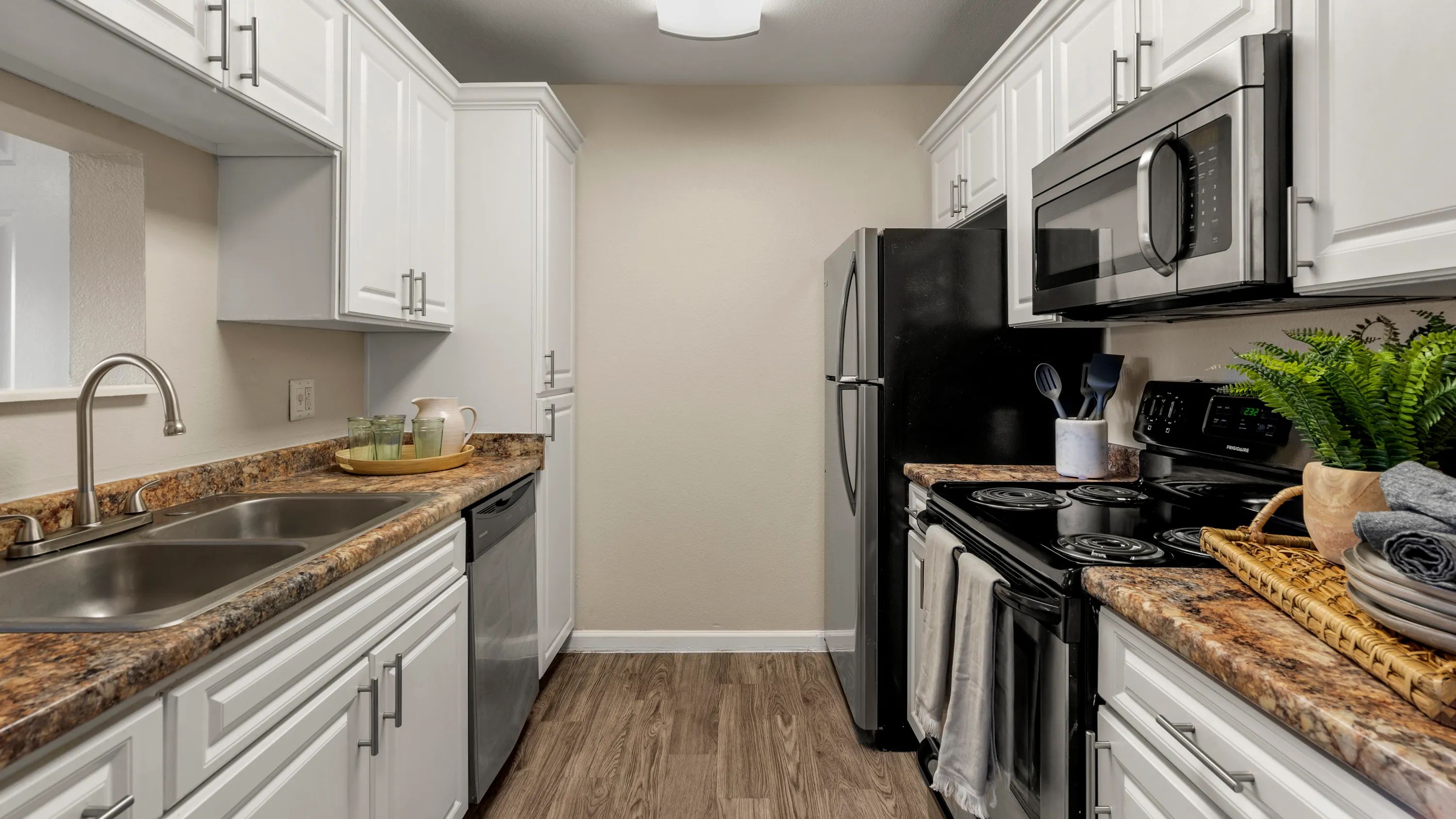 For the culinary enthusiasts, our galley-style kitchen awaits with stainless steel appliances, ample counter space, and abundant cabinetry. 