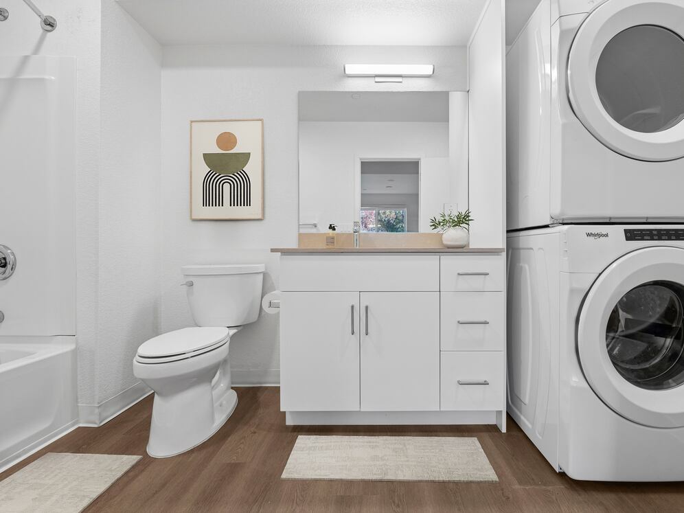 Renovated Package bath with beige quartz countertops, white cabinetry, and hard surface flooring