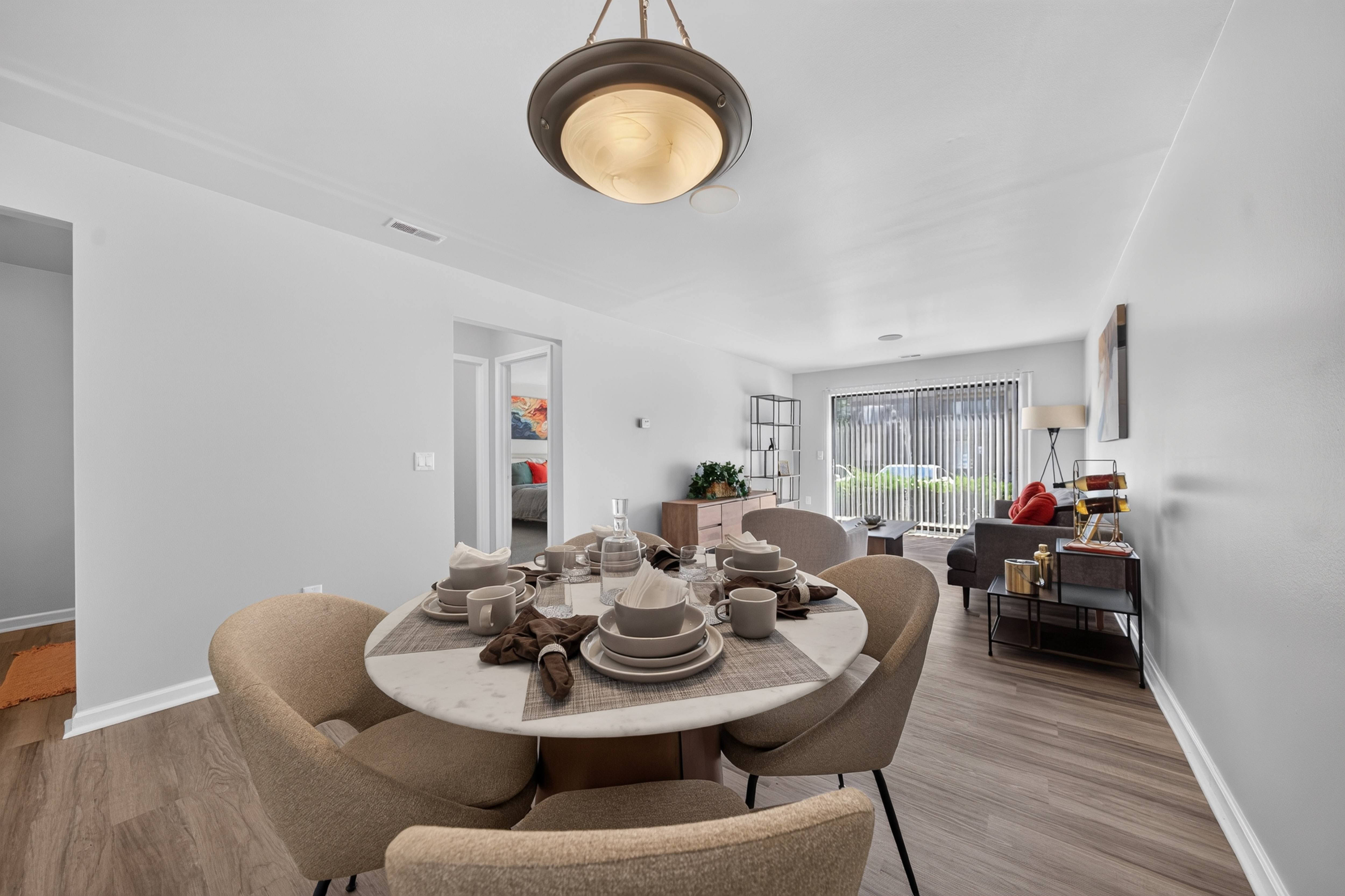 Open concept Living-Dining Area with natural lighting at Lakeside Village Apartments Clinton Township, MI