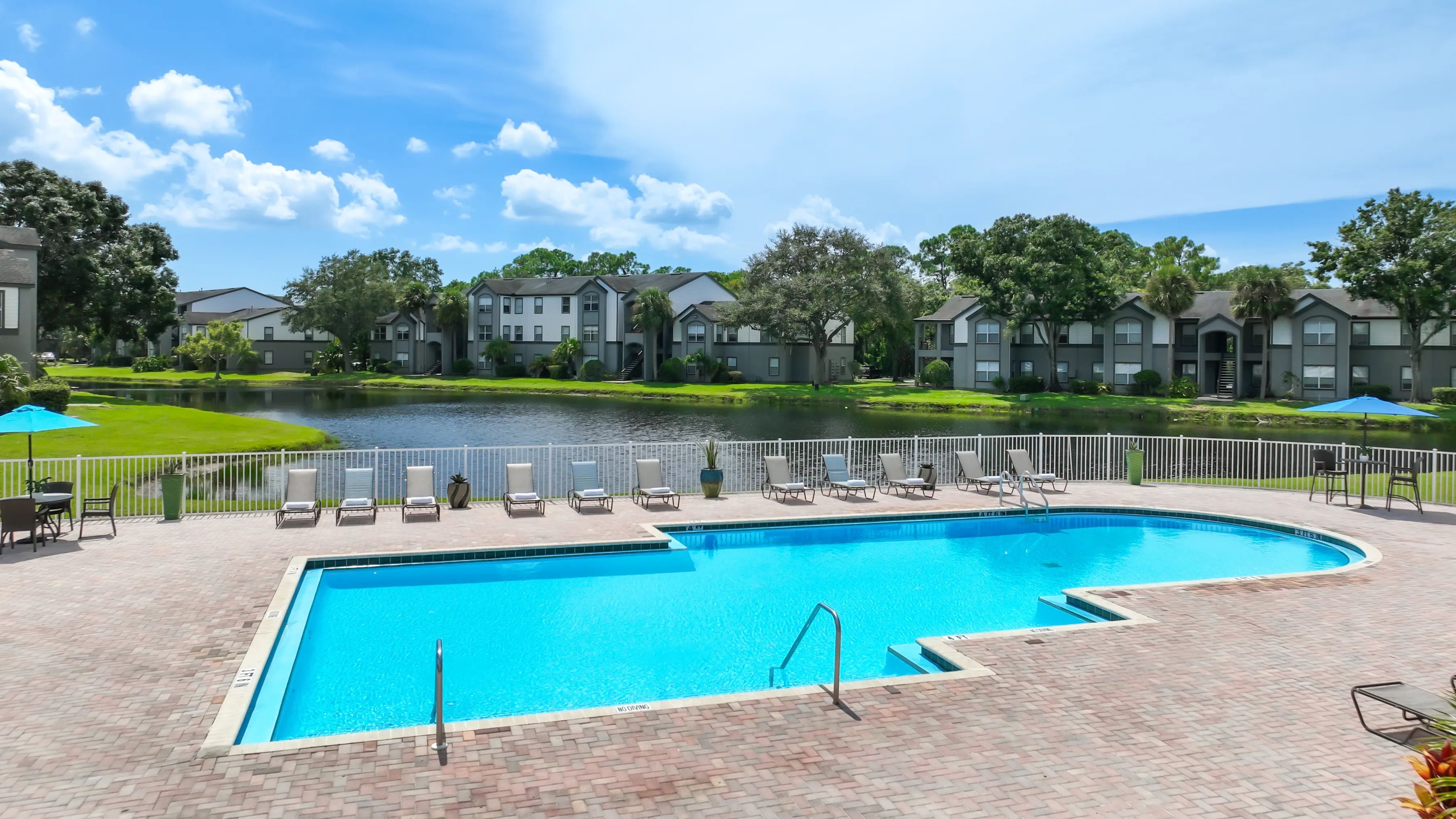 Sun-soaked serenity meets lakeside elegance at our expansive pool and sundeck!