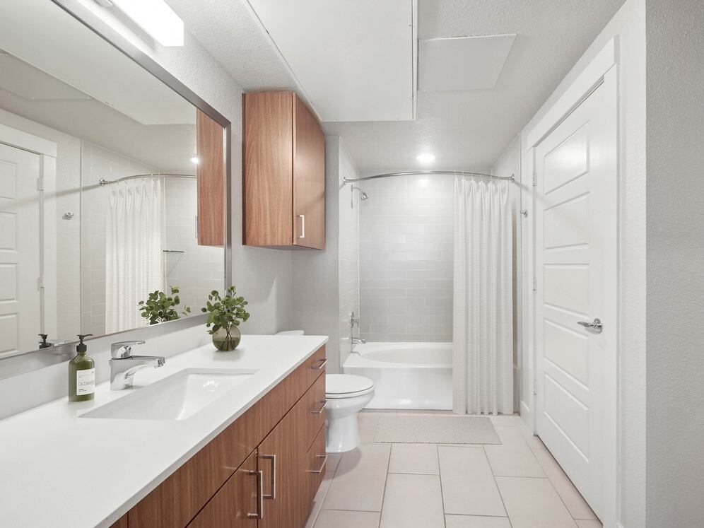 Finish Package I bath with white quartz countertops and dark cabinetry