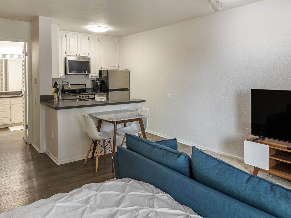 Furnished+ apartment homes include a dining set (Representative Image – exact items and style of furnishings may vary)