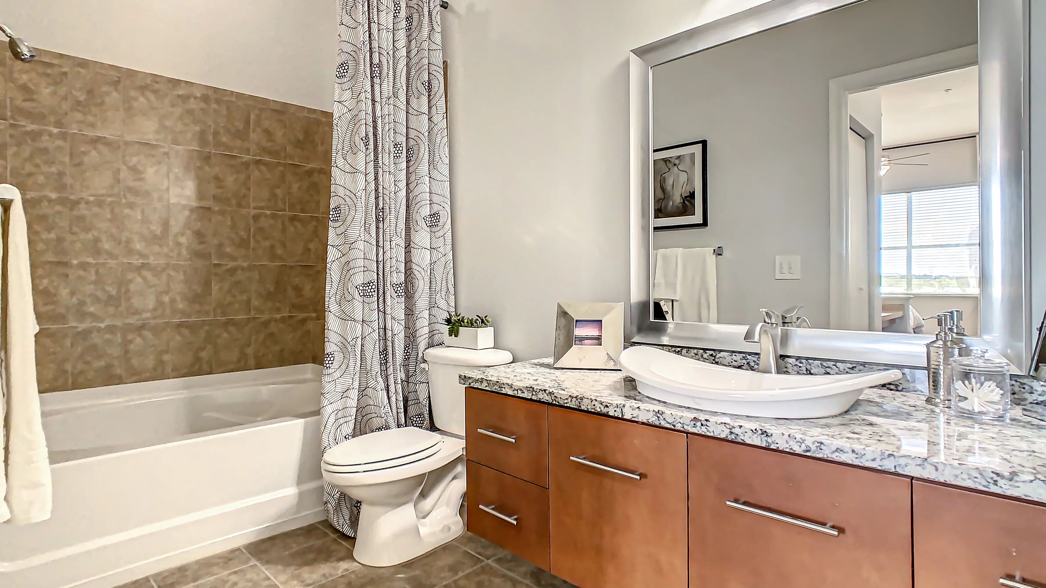 Enjoy an elegant primary bathroom with expansive countertop space, abundant storage, and an oversized garden tub (in select homes).