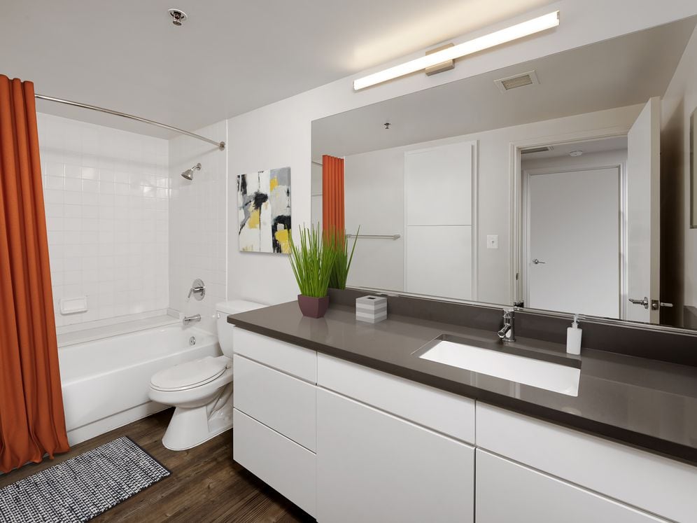 Renovated Package III kitchen, living, and dining areas with hard surface flooring