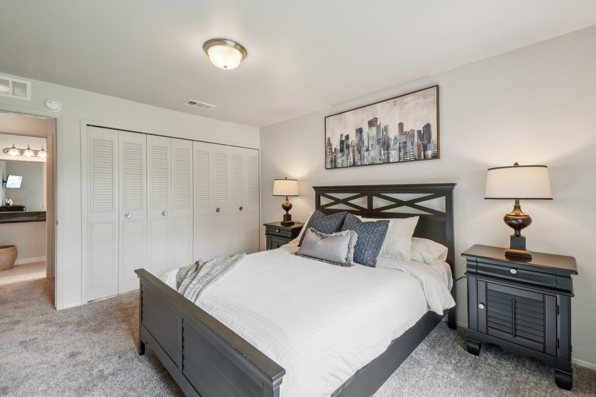Cozy bedroom with ample storage space at Drawbridge Apartments in Harrison Township, MI.