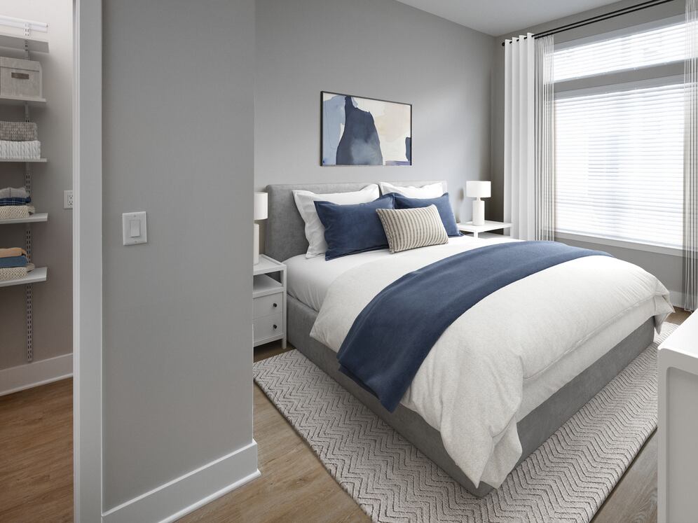 Signature Collection bedroom with walk-in closet and hard-surface flooring