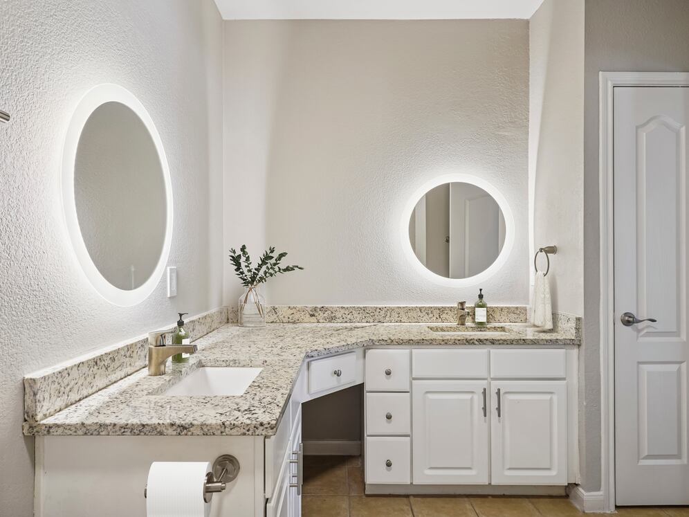 Bath with white cabinetry, speckled granite countertops, and hard surface flooring